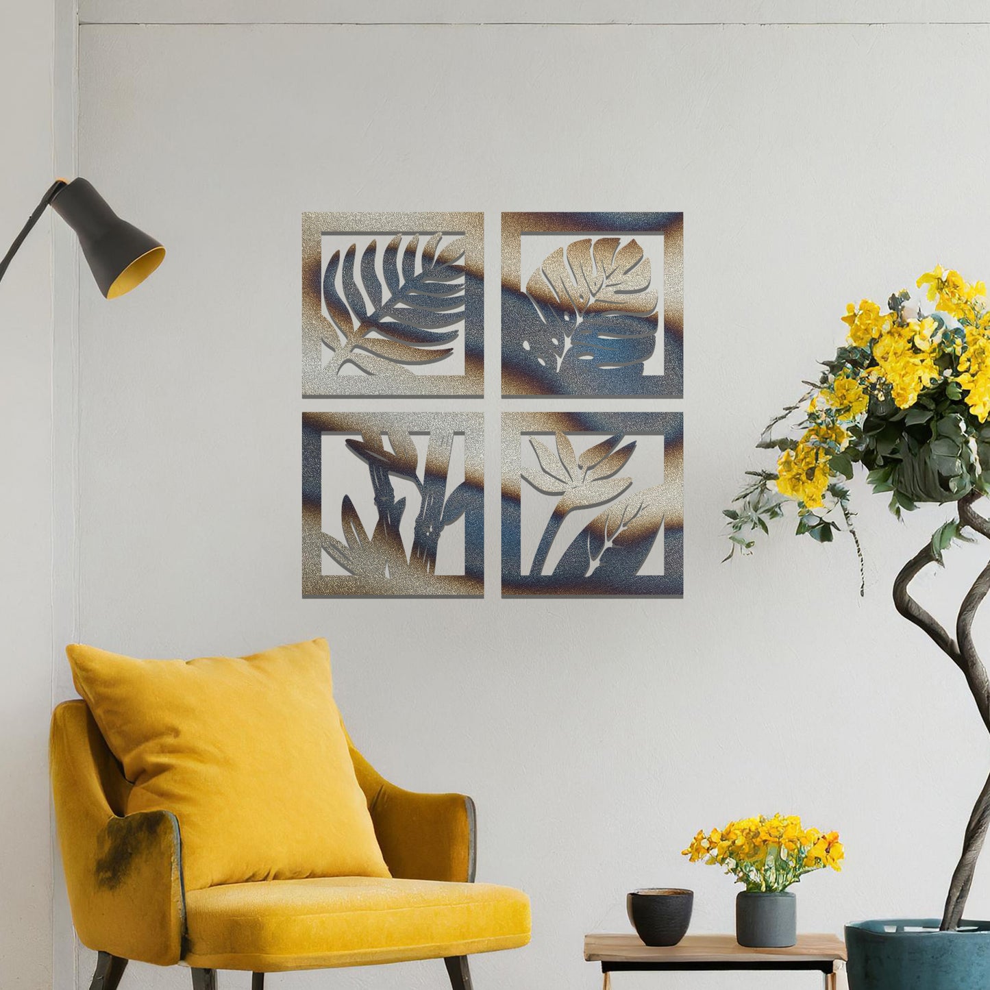 Metal wall art featuring four square panels with intricate leaf designs. The panels showcase detailed plant patterns arranged in a modern layout, mounted on a neutral wall within contemporary room decor, enhancing the room's natural ambiance