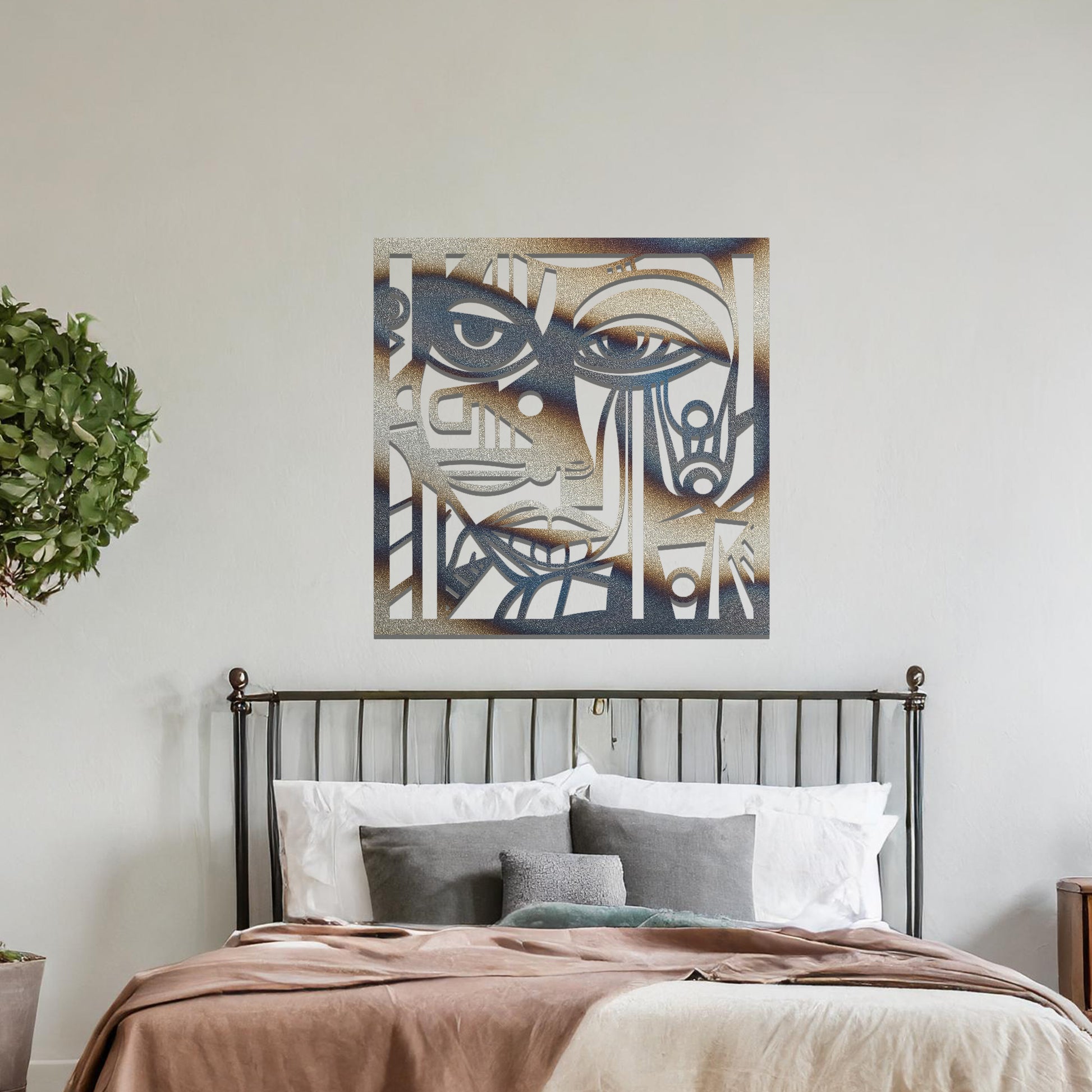 A metal wall art design featuring an abstract face with geometric shapes and sharp lines. The face's features are creatively outlined with strong contrasts, adding a modern, artistic touch to the space. The piece is displayed on a neutral wall, enhancing the room’s decor.