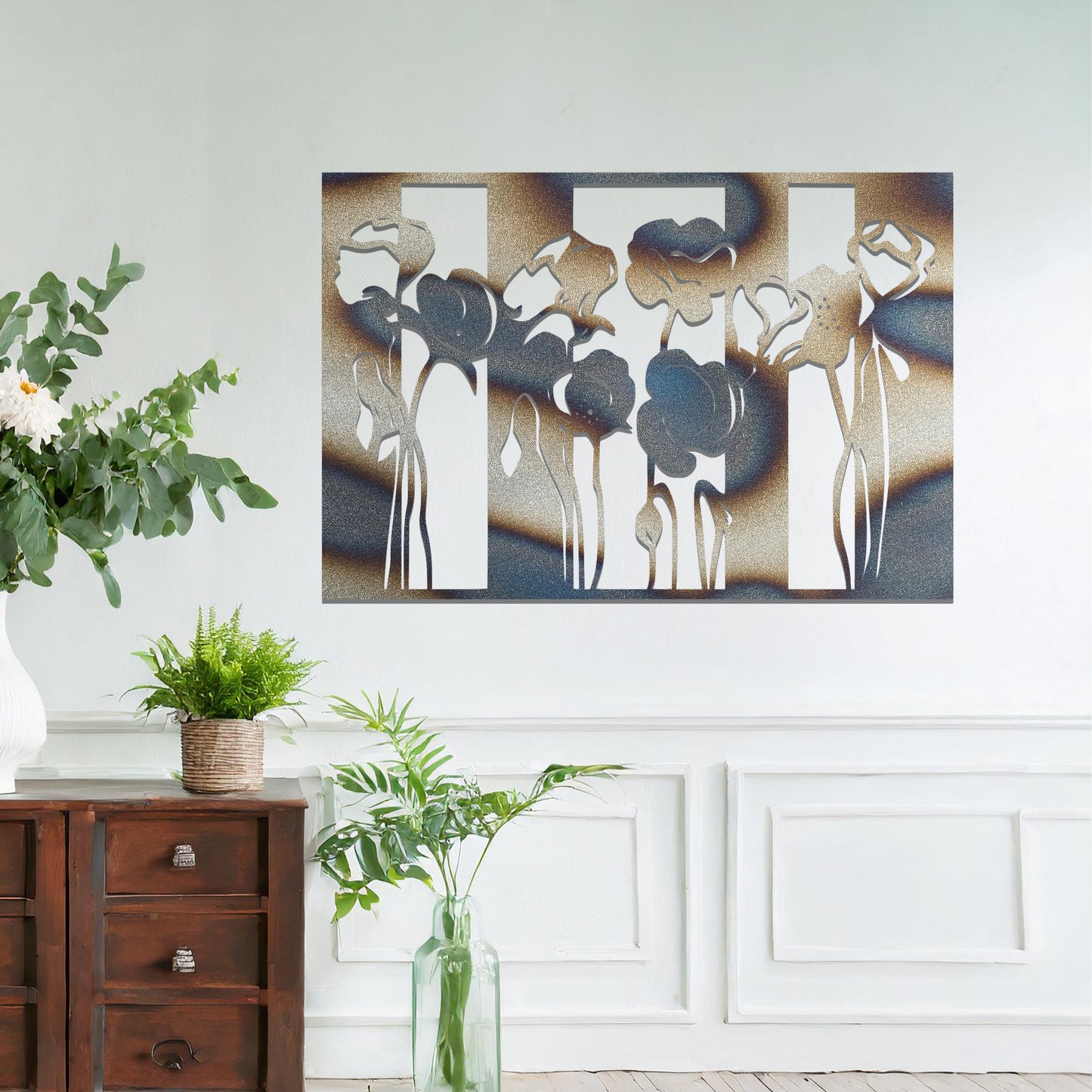 A metal wall art design featuring stylized flowers with long, elegant stems, arranged vertically in a series of three sections. The art is displayed on a neutral wall within a modern room decor, adding a contemporary and artistic touch to the space.