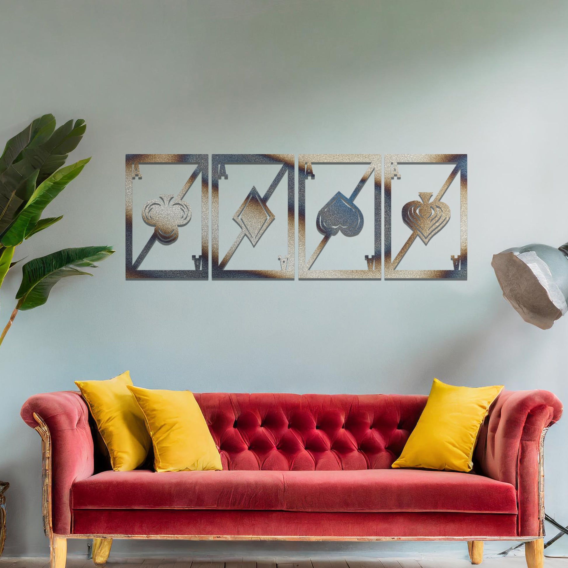 Metal wall art featuring a four-panel design inspired by playing card suits—clubs, diamonds, hearts, and spades—each framed with a modern aesthetic, creating a bold statement piece in the interior setting.