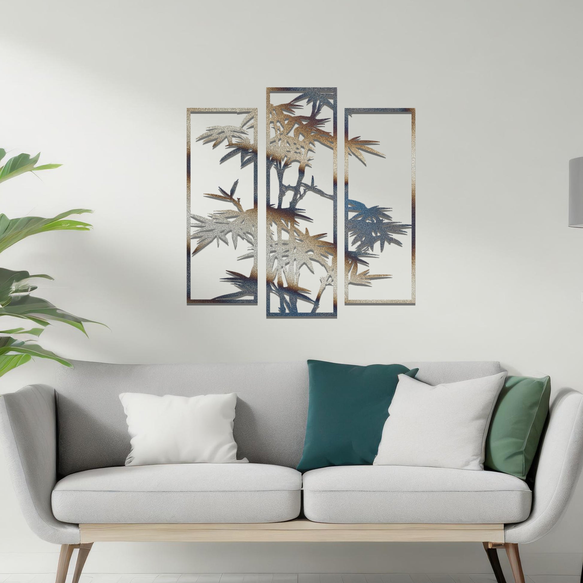 Metal wall art featuring a three-panel bamboo design with intricate leaves and stems, crafted with precise laser-cut detailing, displayed on a neutral wall within modern decor.