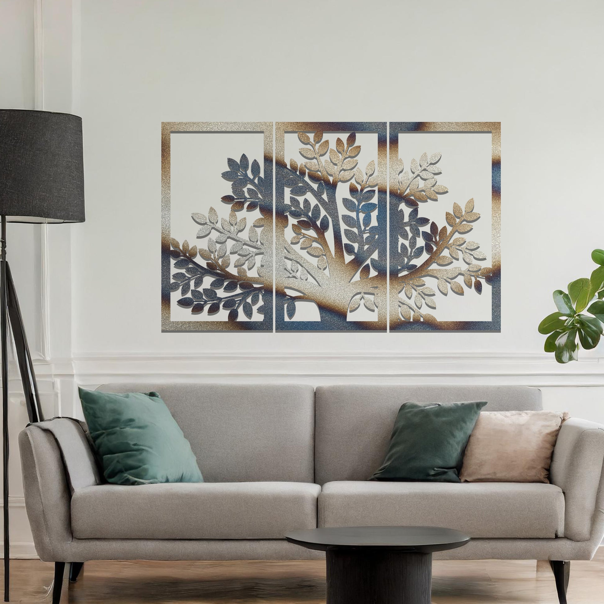 Metal wall art featuring a three-panel tree design with a detailed trunk, branches, and clustered leaves, crafted with precise laser-cut detailing, displayed on a neutral wall within modern decor.