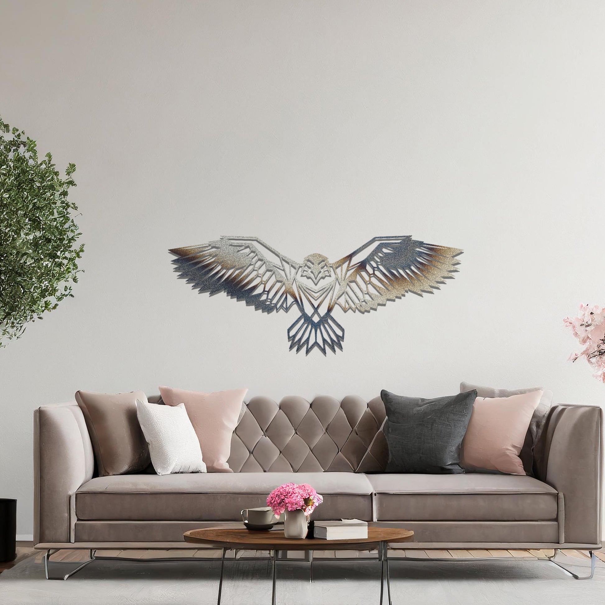 Metal wall art featuring a geometric eagle design with outstretched wings and intricate detailing, crafted with precise laser-cut techniques, displayed on a neutral wall within modern decor.