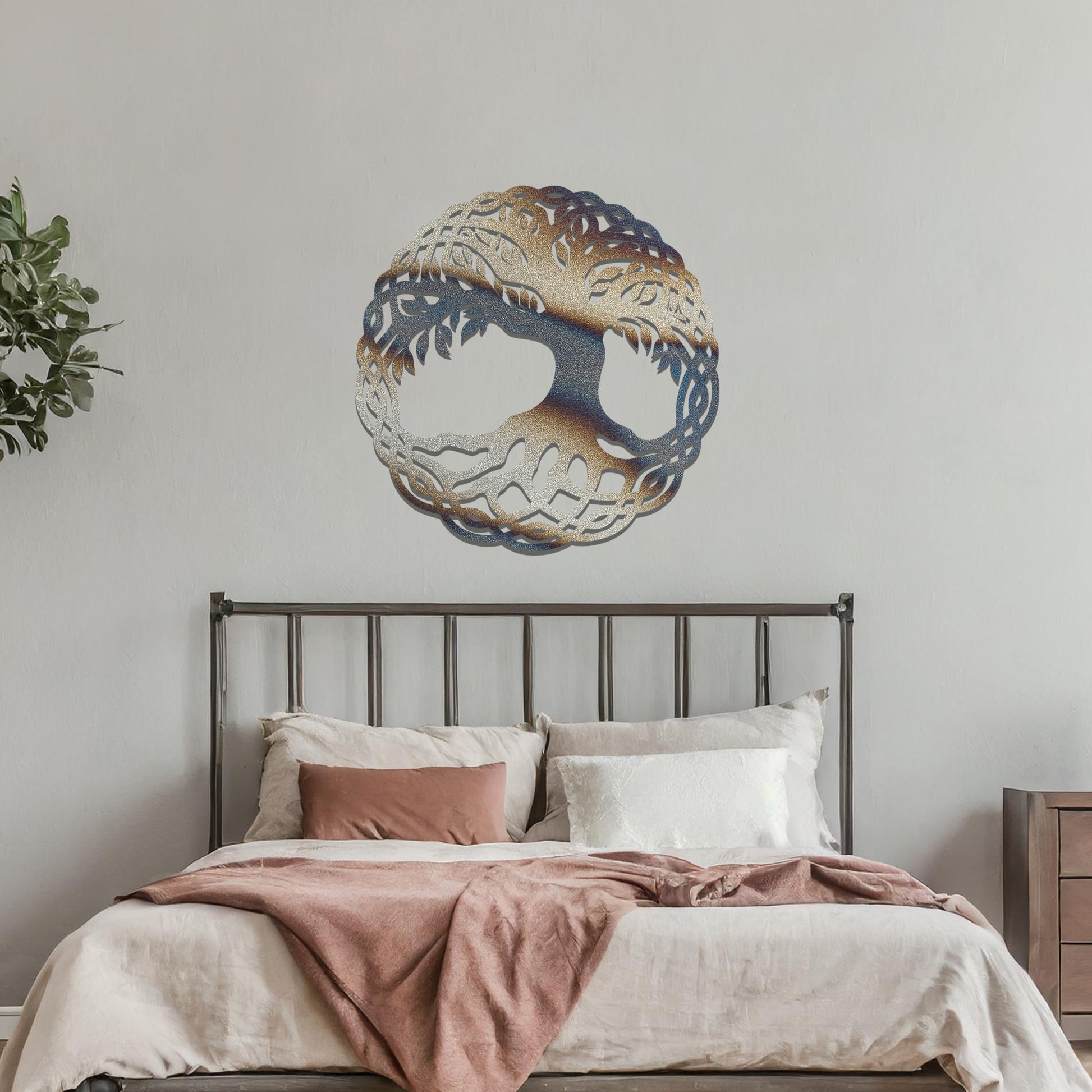 Metal wall art featuring a circular tree of life design with intricate roots and branches enclosed in a detailed border, crafted with precise laser-cut techniques, displayed on a neutral wall within modern decor.