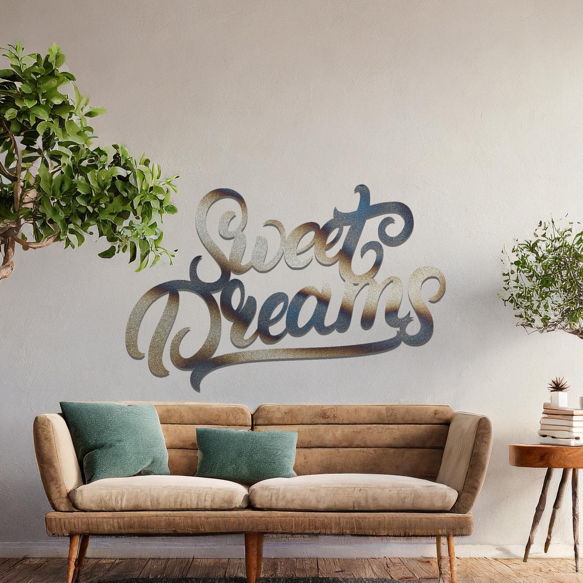 Metal wall art featuring the phrase "Sweet Dreams" in an elegant cursive font, mounted on a neutral wall within modern room decor. The artistic typography adds a charming and comforting focal point, perfect for enhancing the cosy ambiance of the space.