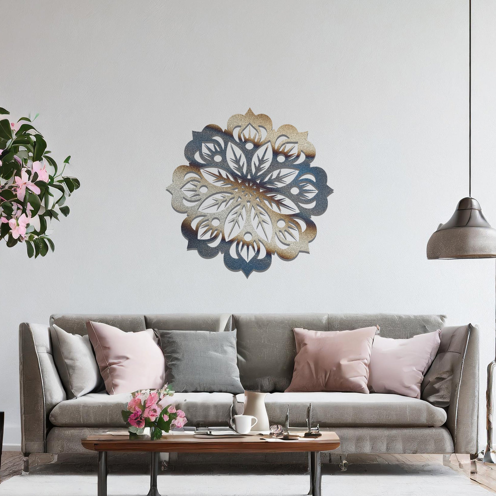 Metal wall art featuring an intricate mandala design with symmetrical floral patterns, mounted on a neutral wall within modern room decor. The detailed craftsmanship and balanced geometry create a striking focal point, enhancing the sophistication of the space.