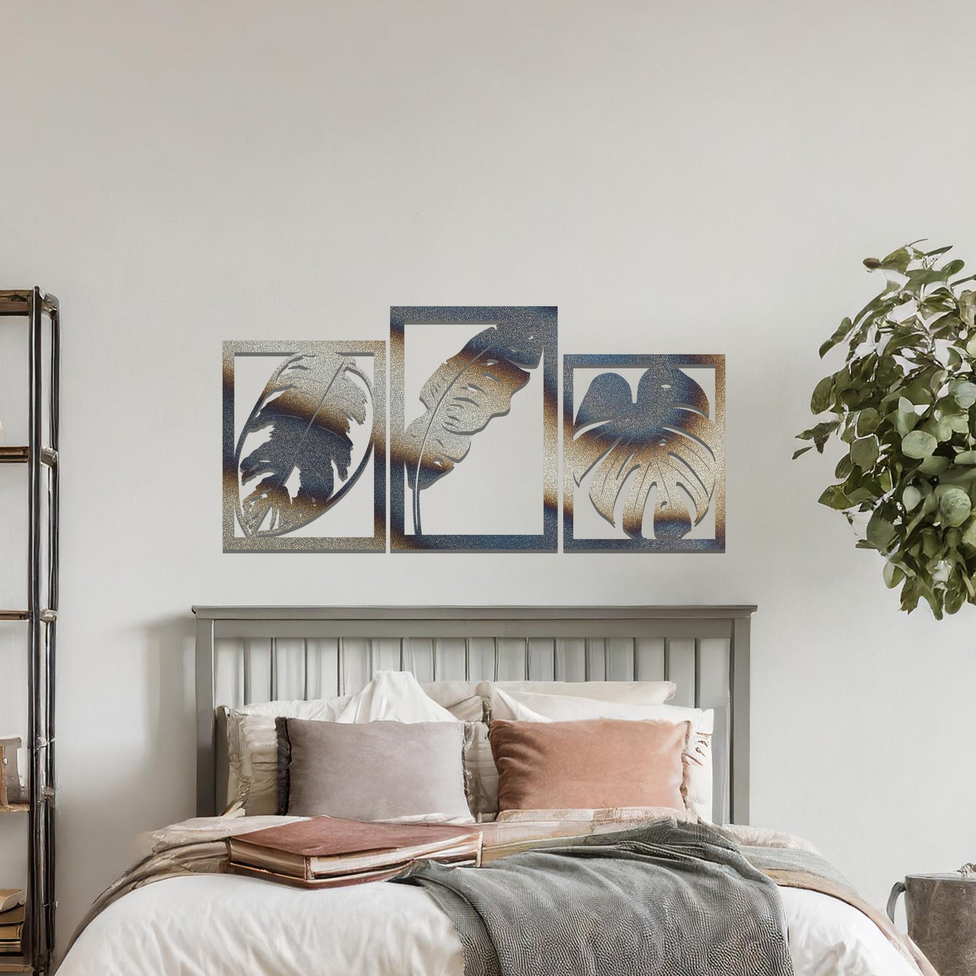 A metal wall art design featuring three leaf patterns, each in its own rectangular frame. The art is displayed on a neutral wall within a modern office space, enhancing the environment with its natural and minimalist appeal.