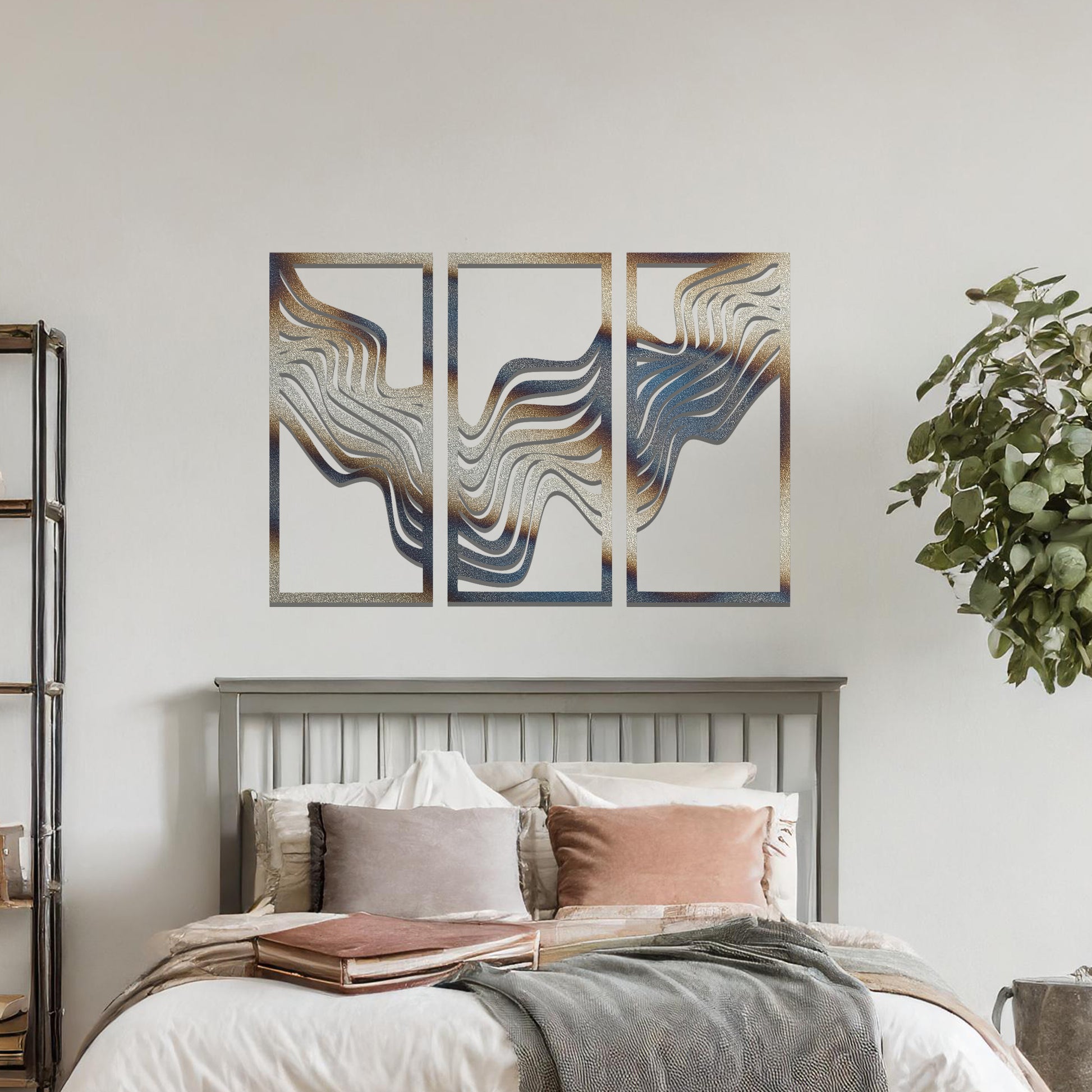 Metal wall art set of three panels featuring flowing, wave-like patterns. The design flows across the panels with a smooth, dynamic movement. The art is placed on a neutral wall in a modern living room, enhancing the space with a sleek, contemporary feel.