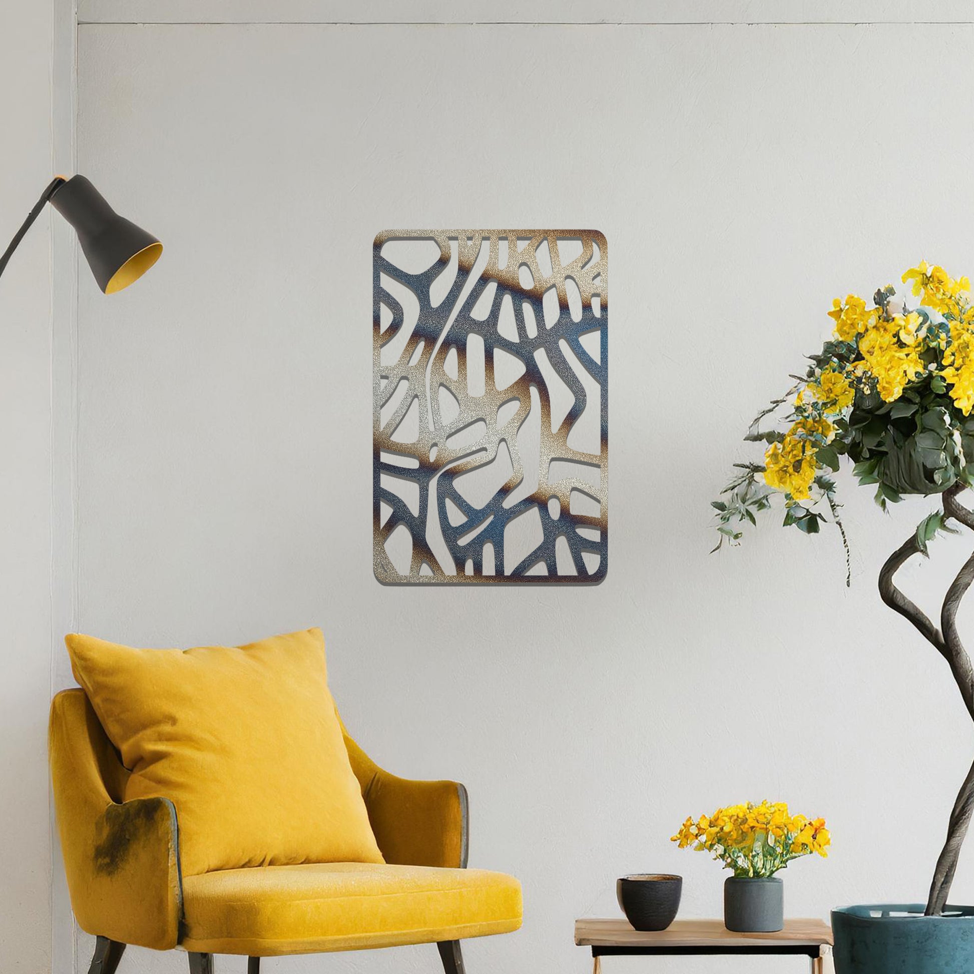 Metal wall art featuring an abstract design with interconnected lines and shapes, creating an organic pattern. The art is placed on a neutral wall within modern living room decor, enhancing the contemporary style of the space.