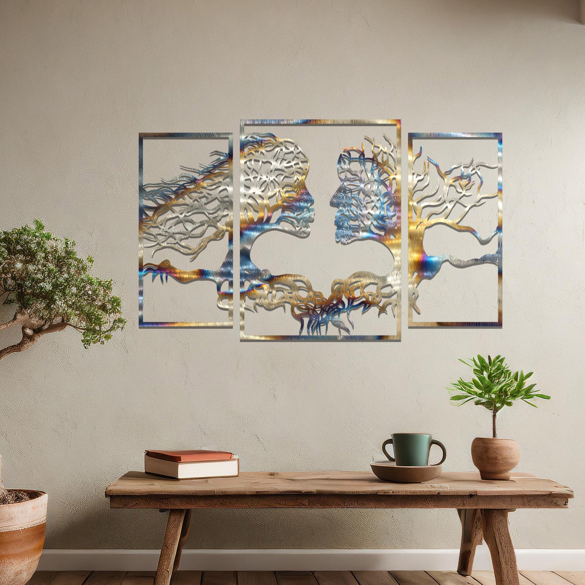 Metal wall art featuring an intricate design of two tree-like figures forming human profiles, crafted with precise laser-cut detailing, framed in panels and placed on a neutral wall within modern decor.