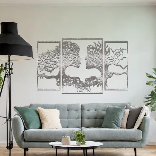 Metal wall art featuring an intricate design of two tree-like figures forming human profiles, crafted with precise laser-cut detailing, framed in panels and placed on a neutral wall within modern decor.