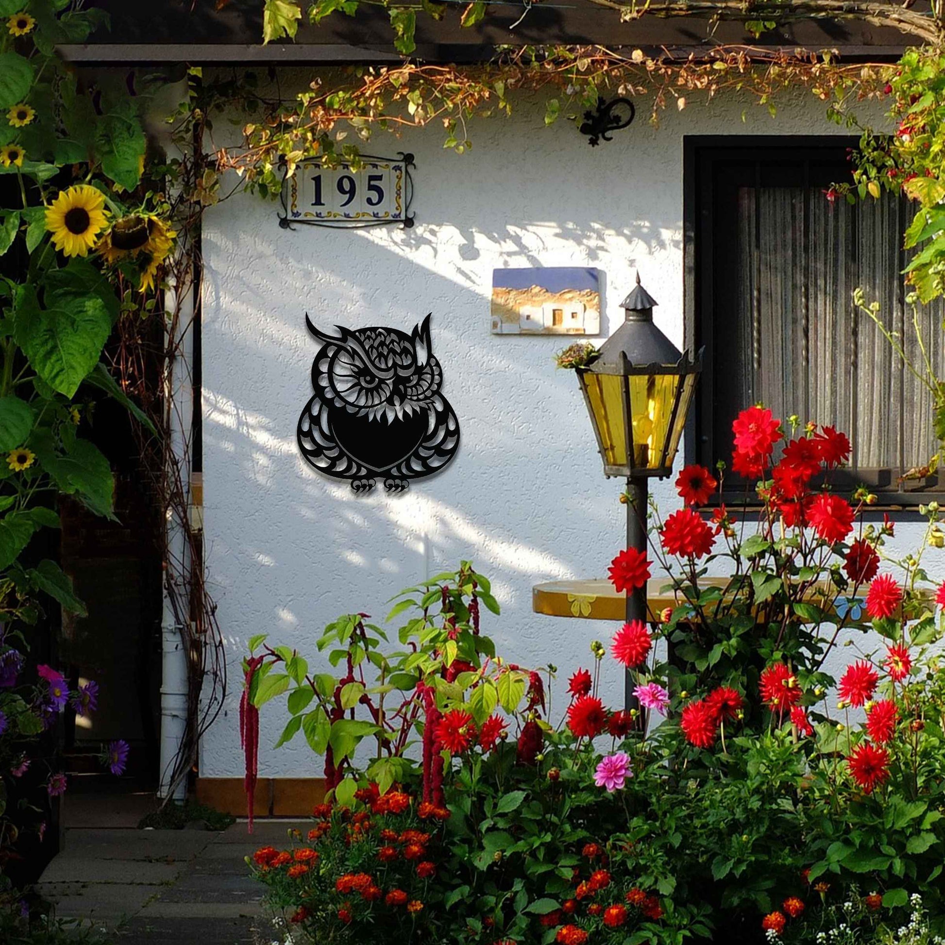 Metal garden decoration featuring a detailed owl design with intricate patterns, adding a touch of nocturnal charm and artistry to outdoor walls, enhancing the beauty of any garden or patio setting.