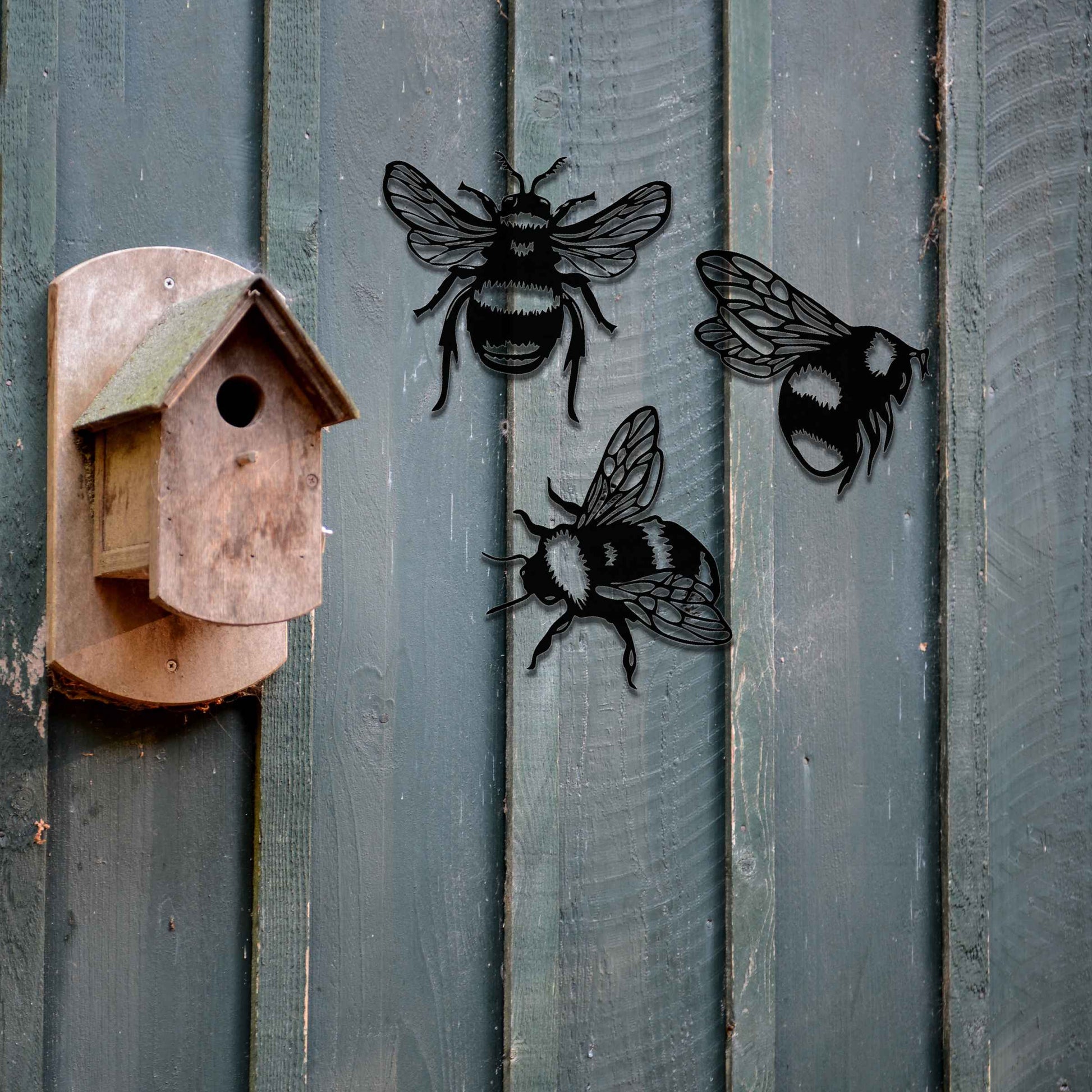 Set of metal garden decorations featuring three detailed bee designs, each showcasing intricate wing and body patterns, perfect for adding a playful and nature-inspired touch to outdoor spaces or fences.