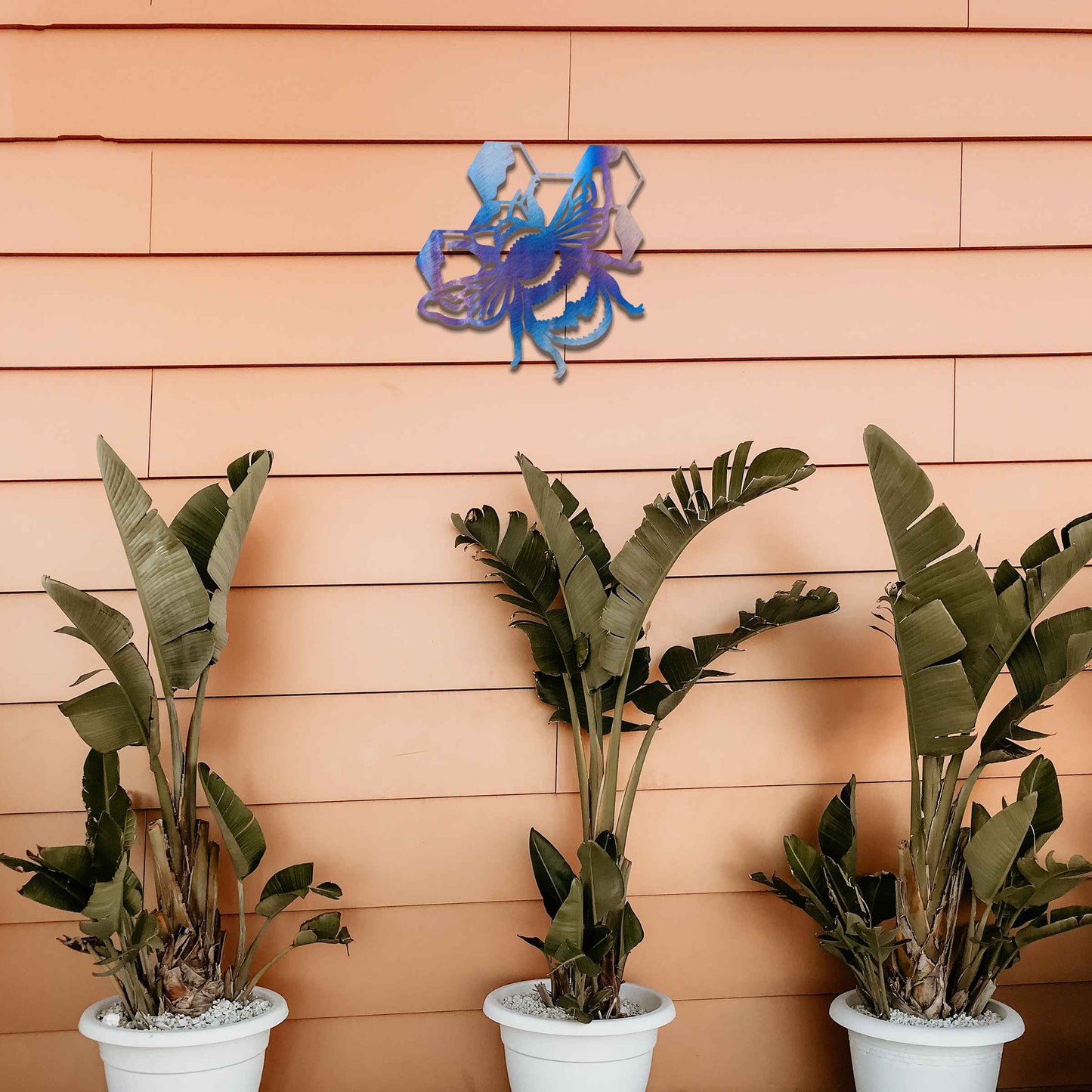 Metal garden decoration depicting a bee with honeycomb elements, intricately designed to enhance outdoor spaces, offering a blend of natural inspiration and rustic charm for garden or patio decor.