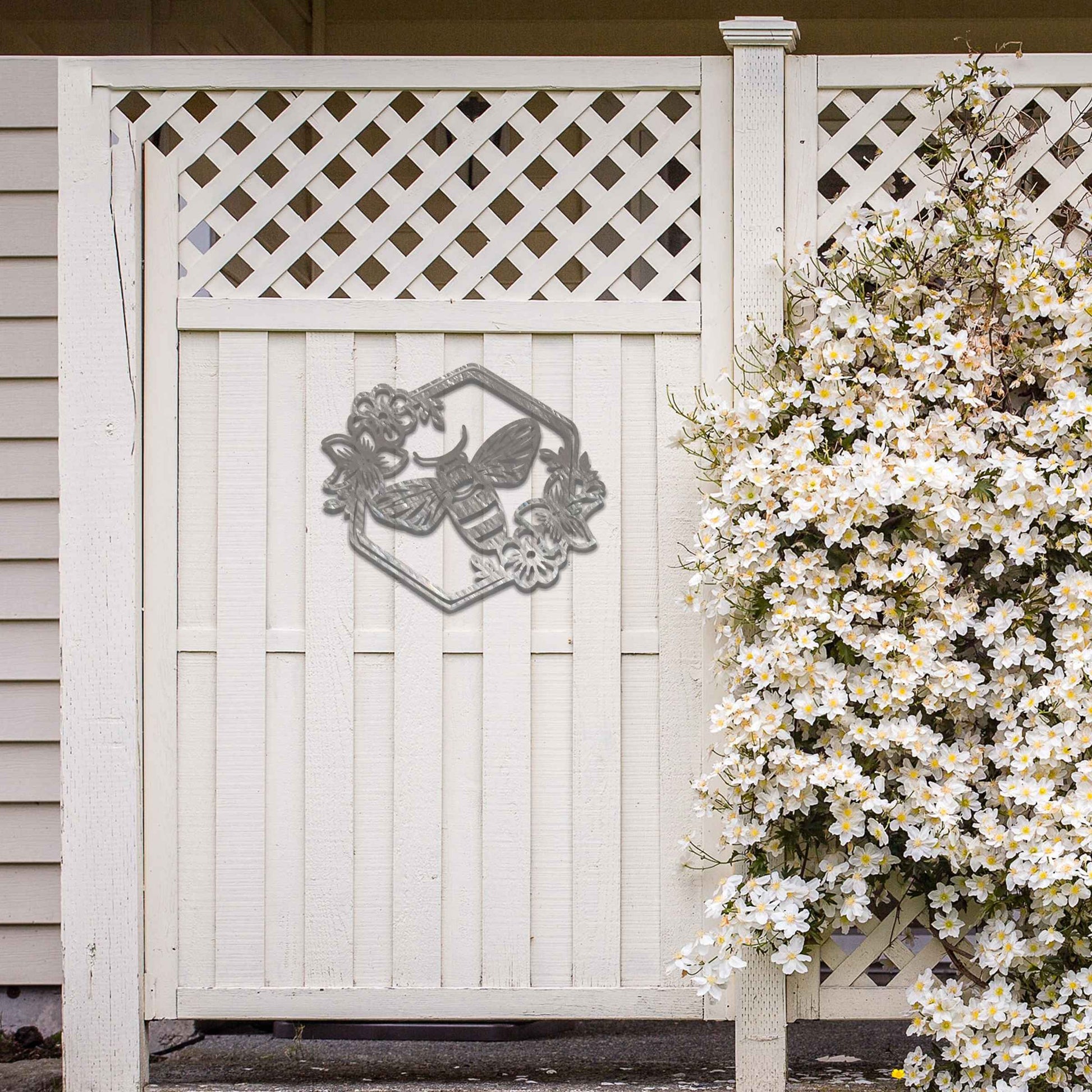 Metal garden decoration showcasing a bee design within a hexagonal frame, adorned with floral details, combining nature-inspired artistry and durability to enhance outdoor spaces with elegance and charm.