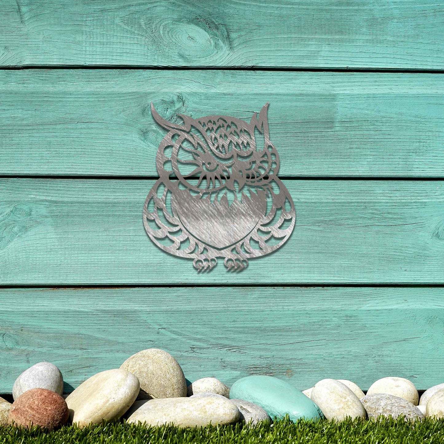 Metal garden decoration featuring a detailed owl design with intricate patterns, adding a touch of nocturnal charm and artistry to outdoor walls, enhancing the beauty of any garden or patio setting.