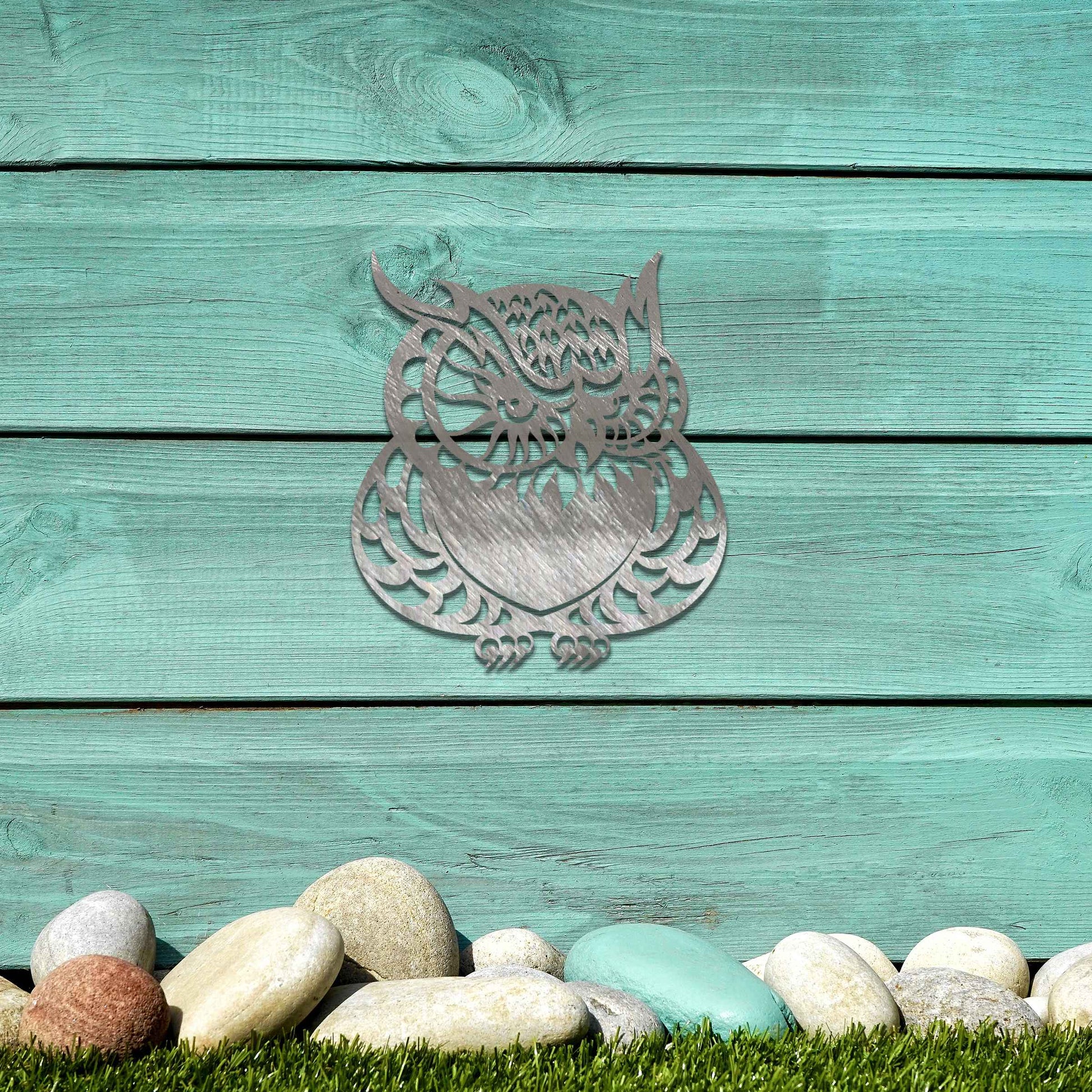 Metal garden decoration featuring a detailed owl design with intricate patterns, adding a touch of nocturnal charm and artistry to outdoor walls, enhancing the beauty of any garden or patio setting.