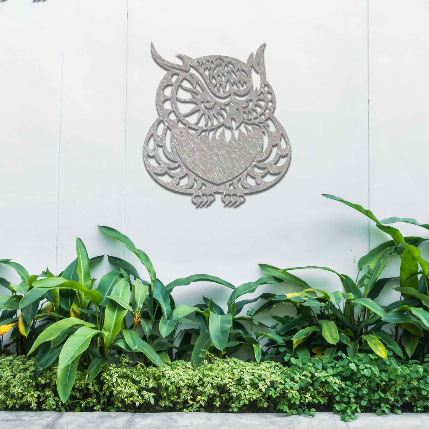 Metal garden decoration featuring a detailed owl design with intricate patterns, adding a touch of nocturnal charm and artistry to outdoor walls, enhancing the beauty of any garden or patio setting.