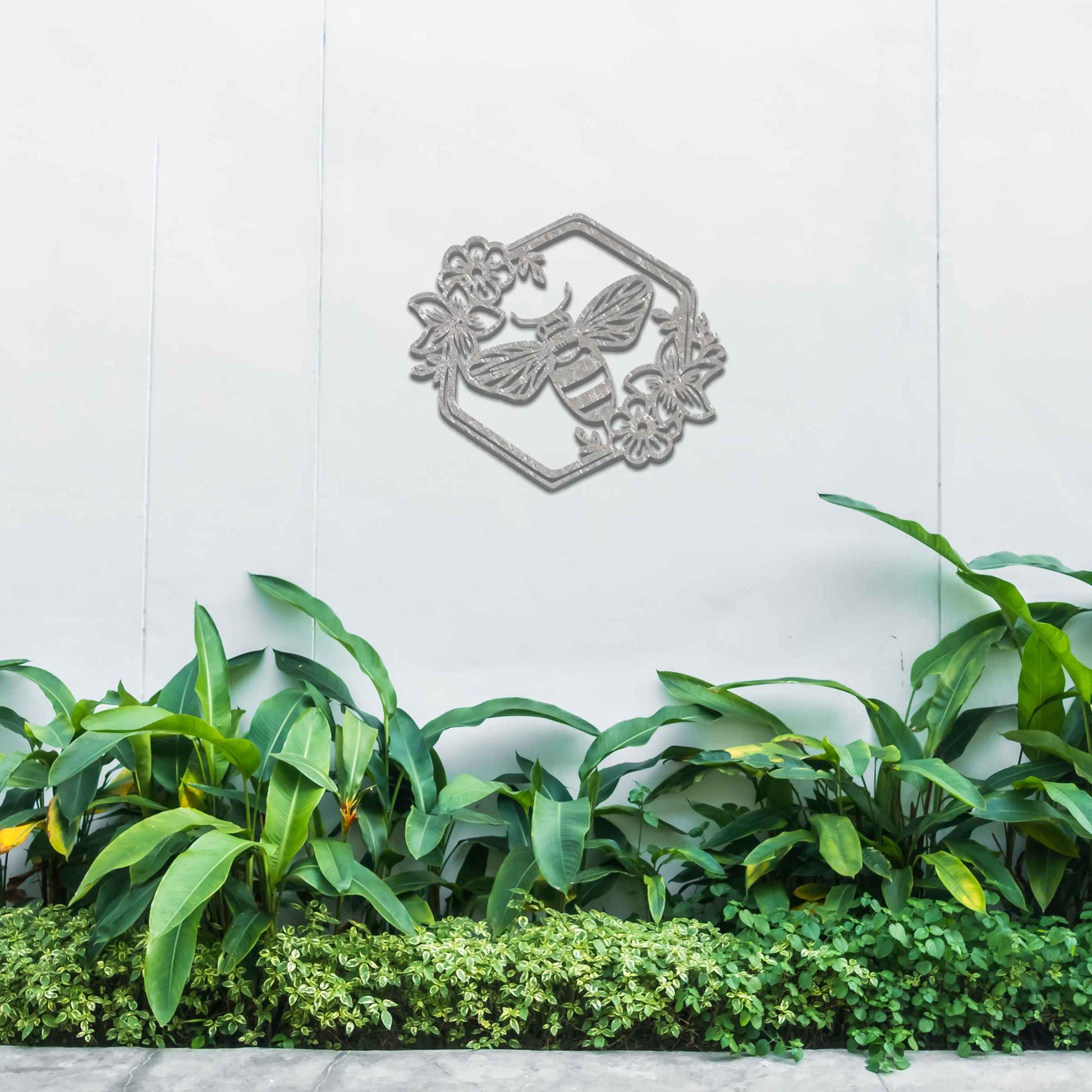 Metal garden decoration showcasing a bee design within a hexagonal frame, adorned with floral details, combining nature-inspired artistry and durability to enhance outdoor spaces with elegance and charm.