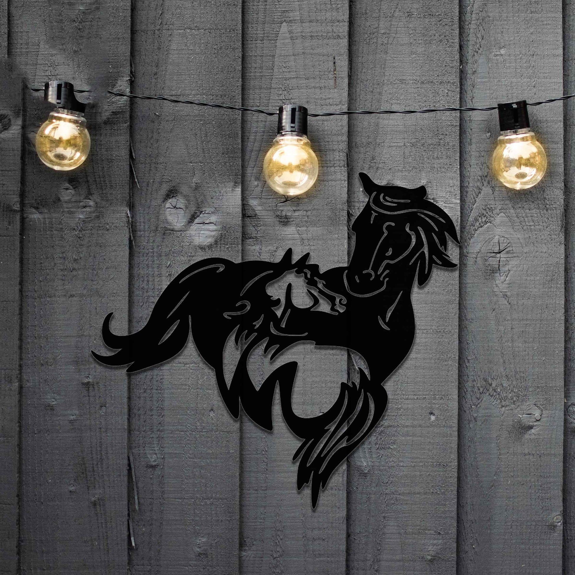 Metal wall decoration featuring a large horse with a smaller horse standing beside it, crafted with intricate cutout details and a rustic finish, adding a graceful and heartwarming touch to indoor or outdoor spaces.