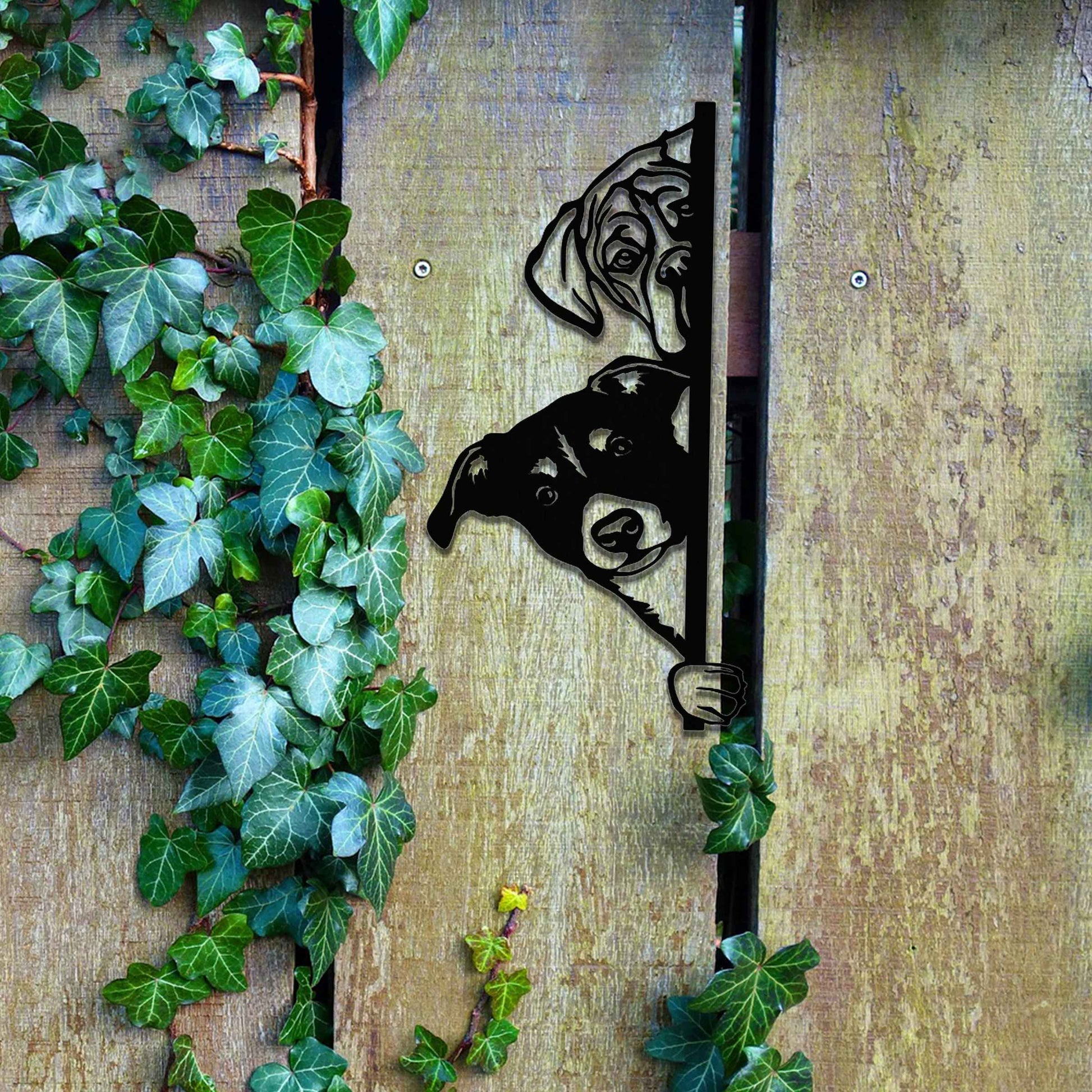 This image features a playful dog peeking through a gate, captured in a rusted finish. Its curious expression brings a whimsical touch to the surroundings, creating an inviting, charming atmosphere for any garden or outdoor space.