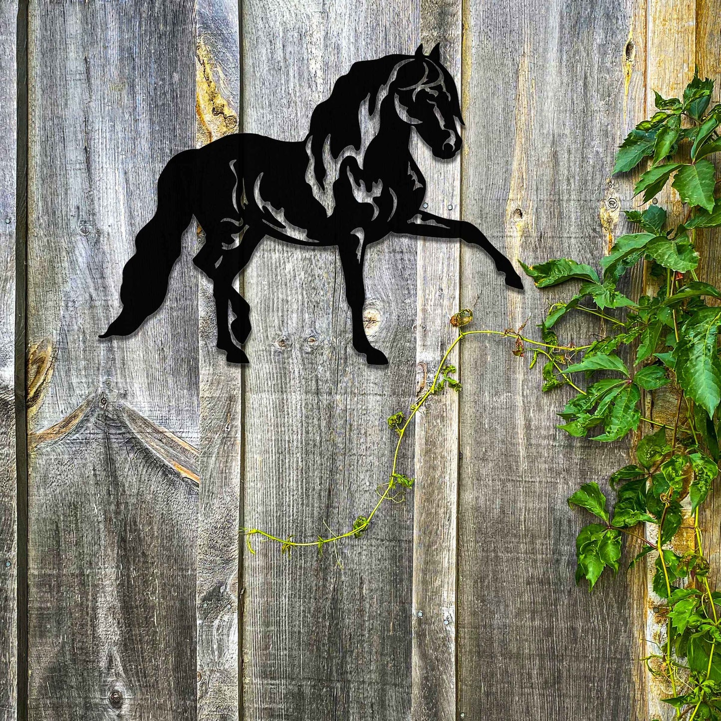 Metal wall art of a horse with a proud stance, featuring flowing mane and tail, captured in a dynamic pose. The design emphasizes strength and elegance, showcasing the horse's muscular form.