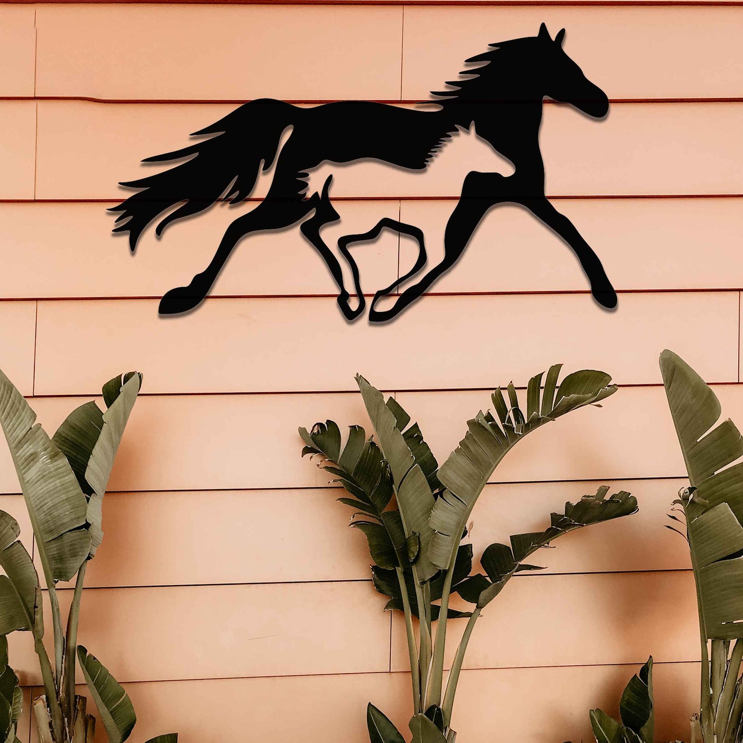 Metal wall art of a running horse, captured in motion with flowing mane and tail. The horse is designed with fluid lines, giving a dynamic impression of speed and energy.