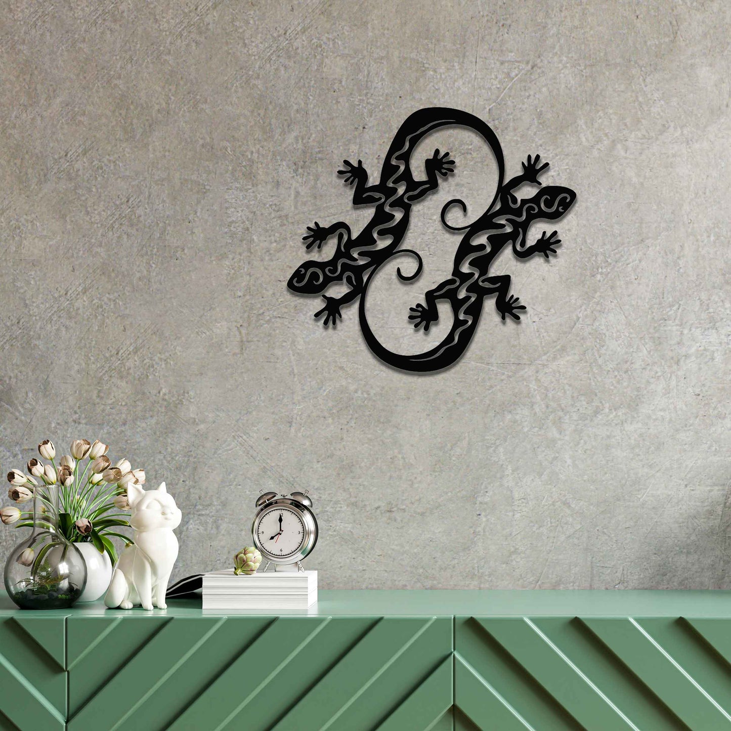 Metal wall decoration featuring two intertwined gecko designs with flowing and curved patterns, adding a dynamic and modern artistic touch to indoor spaces, displayed on a neutral wall within contemporary decor.