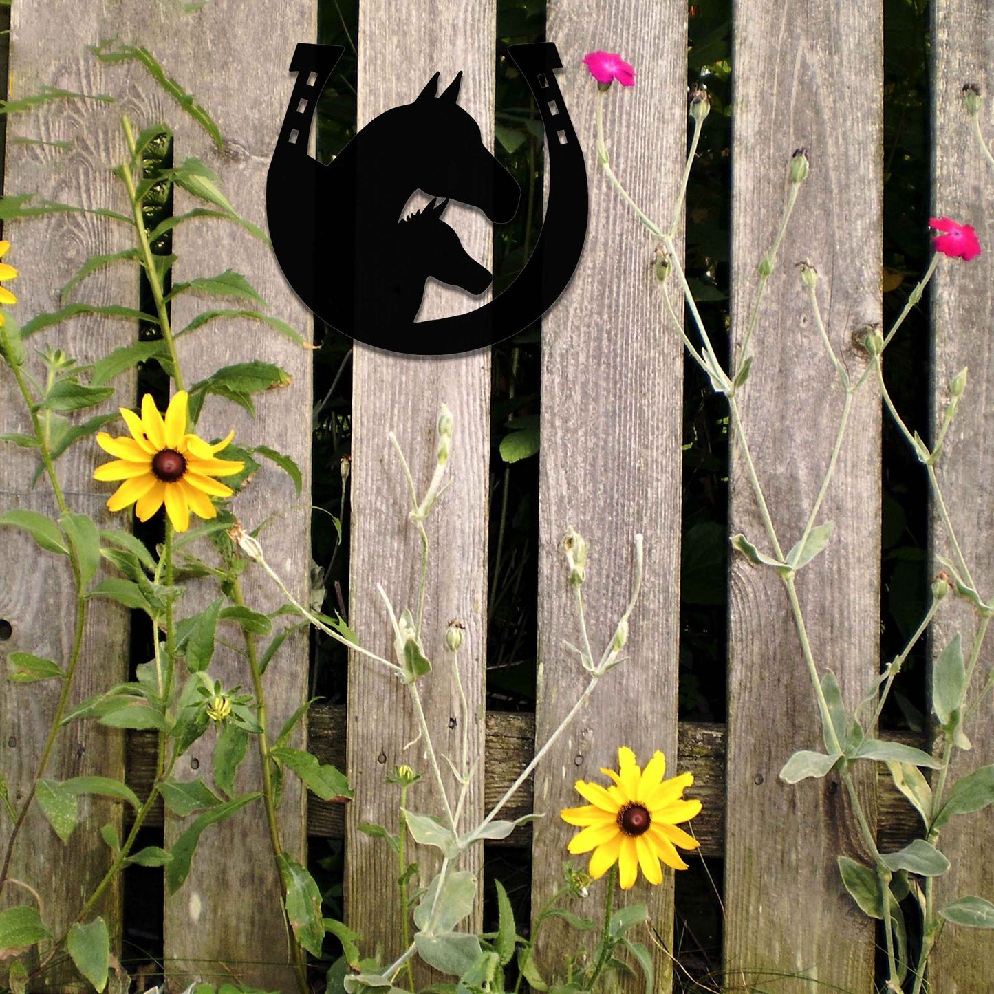 Metal garden decoration featuring a horse silhouette enclosed within a horseshoe design, crafted with a rustic finish, adding a touch of equestrian charm and character to outdoor walls or garden spaces