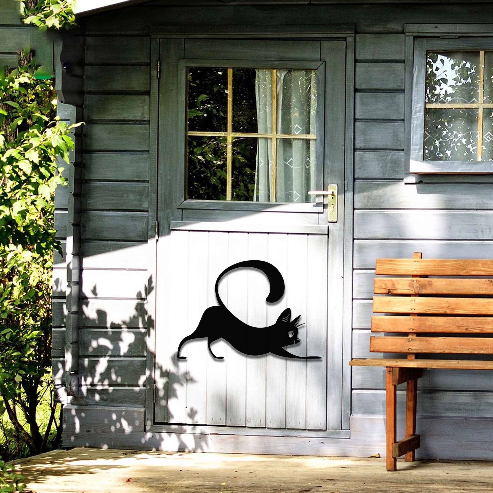 Metal garden decoration featuring a playful cat stretching with its tail curved upwards, crafted with sleek and elegant detailing, adding a touch of charm and liveliness to outdoor walls, fences, or doors.