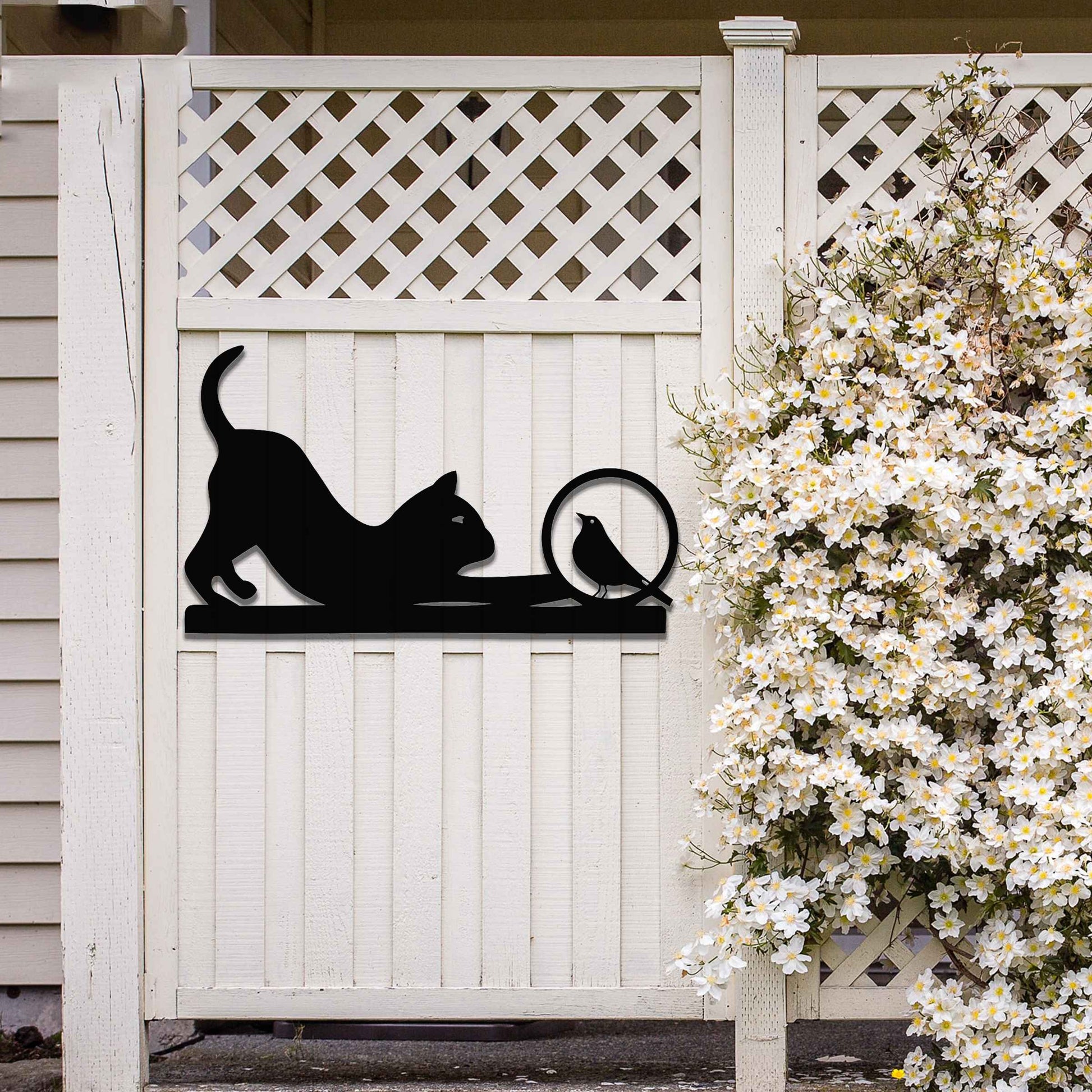 Metal wall art featuring a playful cat crouching in curiosity with a bird perched nearby, perfect for adding a touch of whimsy and nature-inspired charm to your garden, fence, or outdoor decor.