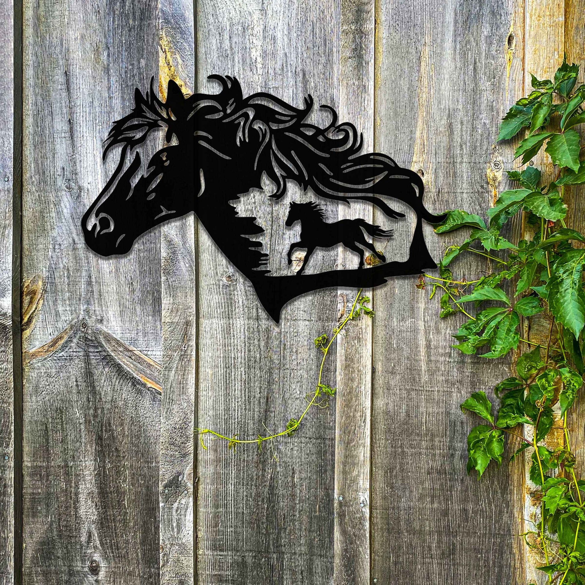 Metal wall decoration featuring a horse head silhouette with flowing mane details and a smaller horse figure within, crafted with intricate cutouts and a rustic finish, adding a majestic and artistic touch to indoor or outdoor spaces.