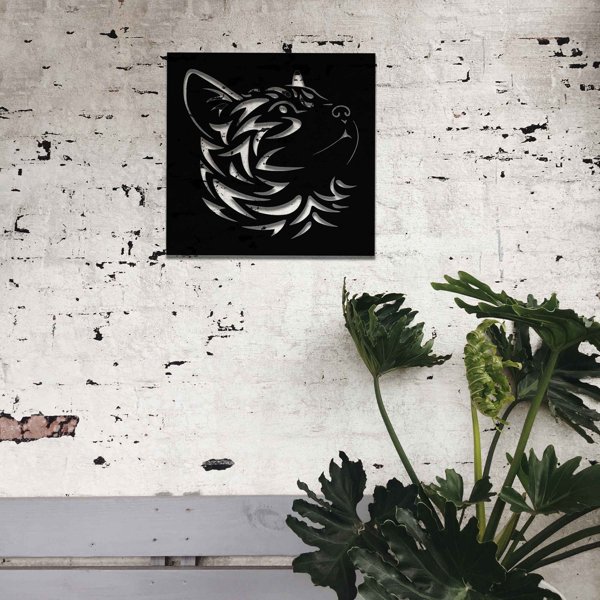 This artwork features a captivating metal design of a cat's face with intricate cut-out details, perfect for a modern, minimalistic decor setting. The cat's profile is beautifully crafted, adding a touch of elegance to any space.