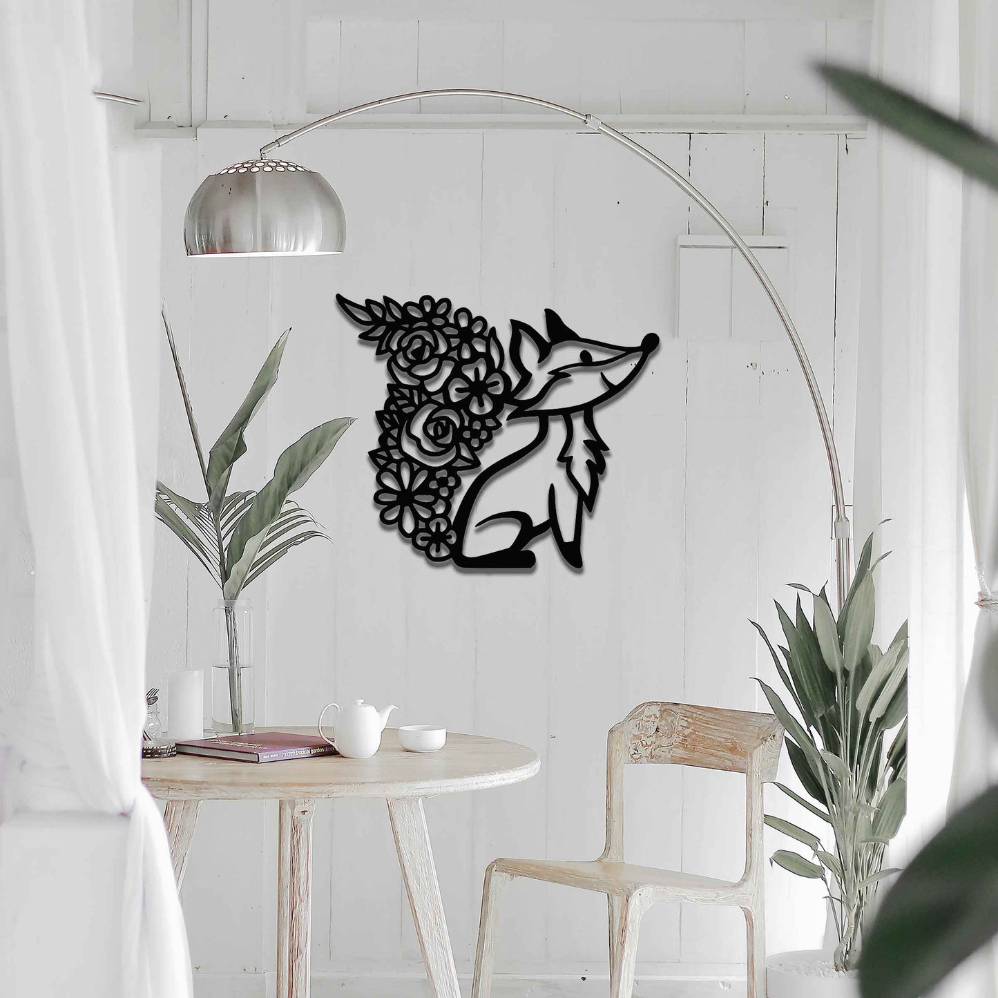 Metal wall decoration featuring a fox silhouette with a floral-patterned tail, crafted with intricate cutout details and a rustic finish, adding a whimsical and elegant touch to indoor or outdoor spaces.