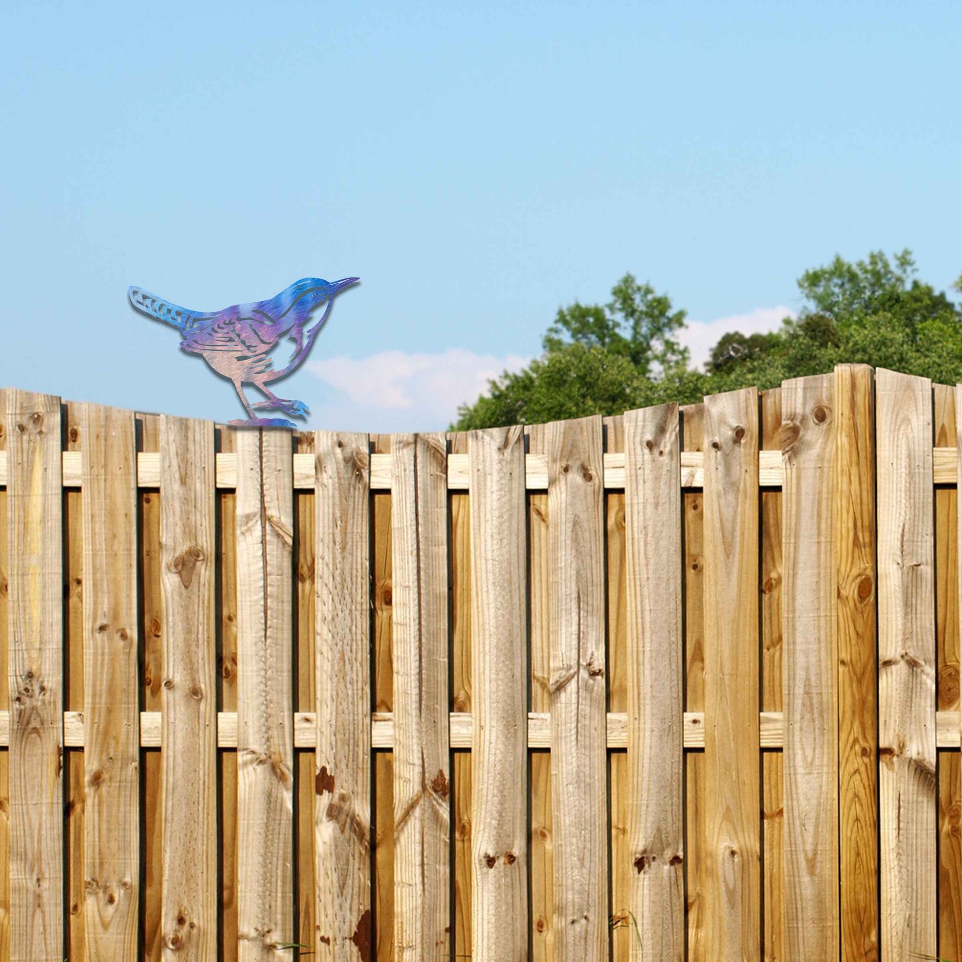Metal garden decoration featuring a wren silhouette with intricate cutout details and a rustic finish, designed to sit atop fences or posts, adding a delicate and natural charm to outdoor spaces.
