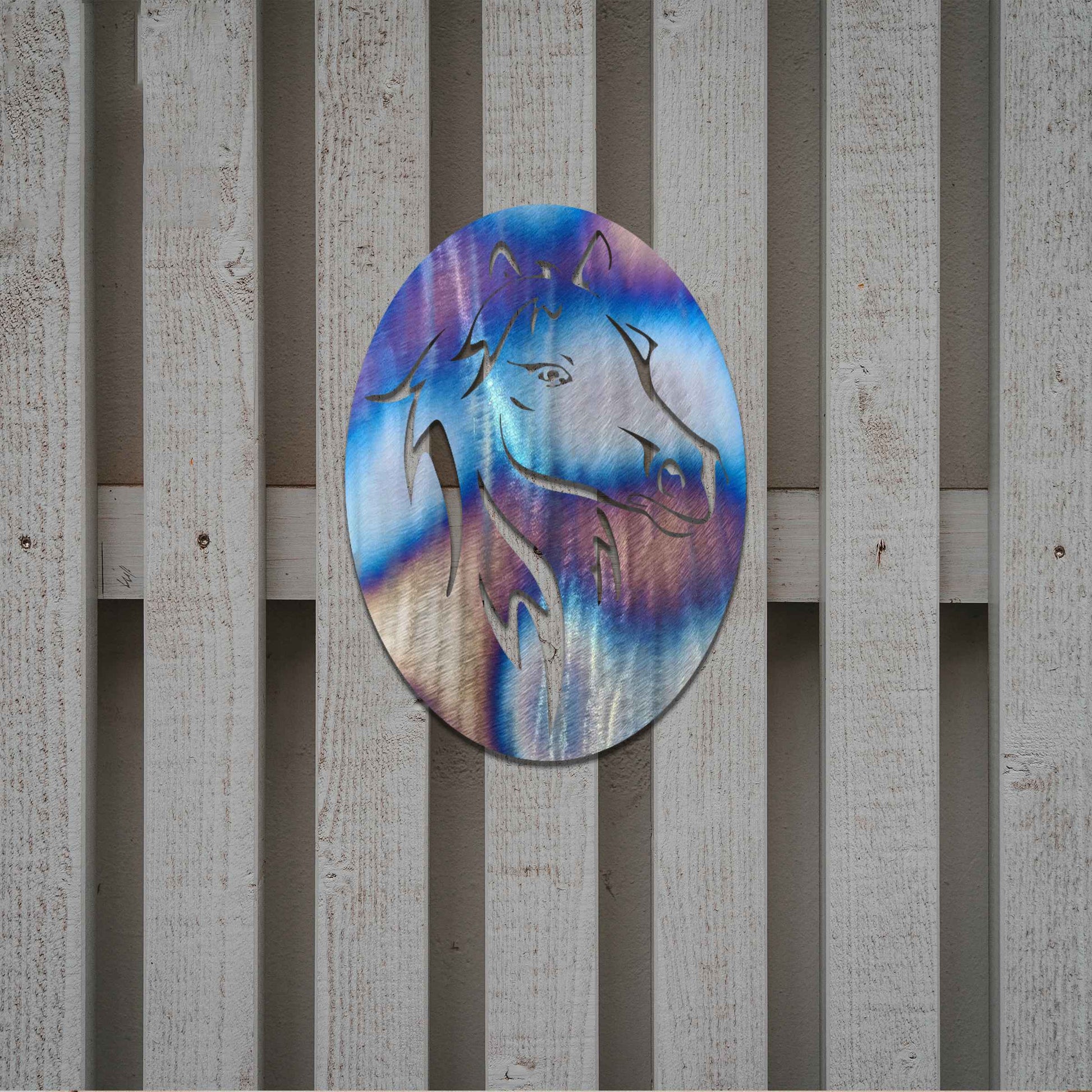 Metal wall art featuring a horse's head within an oval frame, highlighting intricate details of the mane and facial features. The design is bold and dynamic, capturing the strength and elegance of the horse in a stylized and striking manner.