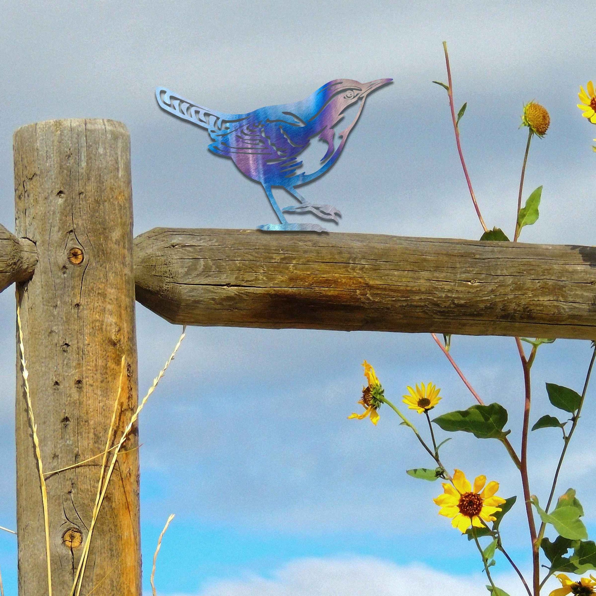 Metal garden decoration featuring a wren silhouette with intricate cutout details and a rustic finish, designed to sit atop fences or posts, adding a delicate and natural charm to outdoor spaces.