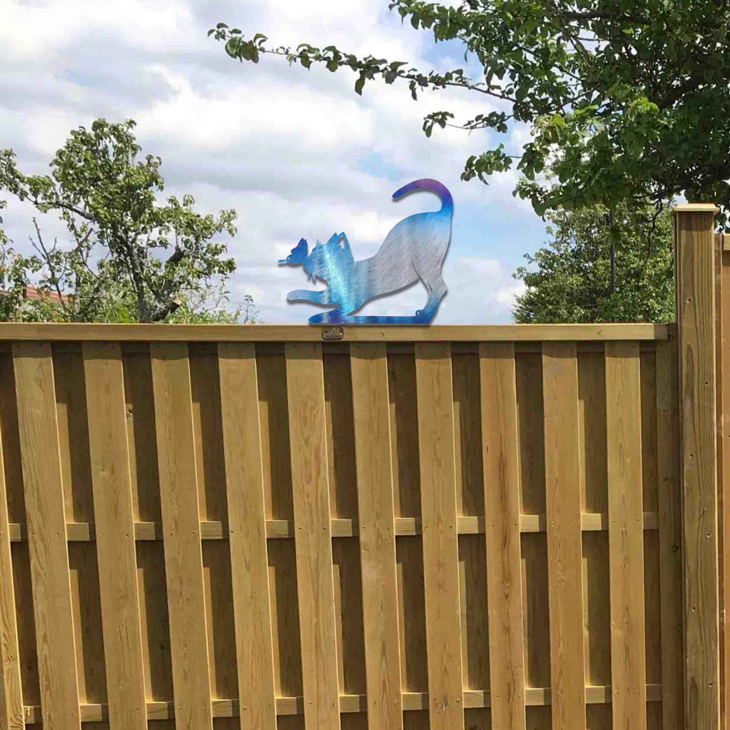 Metal garden decoration featuring a playful stretching cat silhouette with a rustic finish, designed to sit atop fences or posts, adding a whimsical and charming touch to outdoor garden settings.