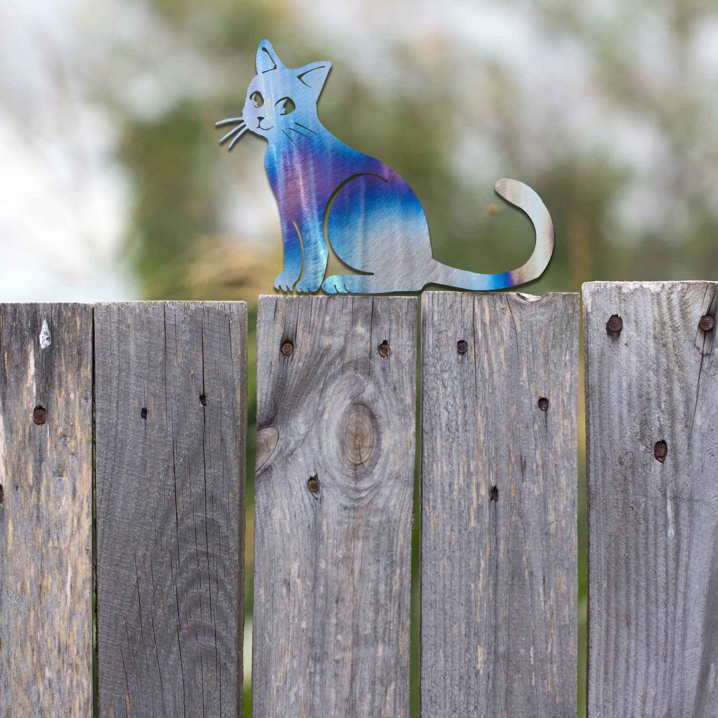 Metal garden decoration featuring a sitting cat silhouette with a rustic finish, designed to adorn fence tops or garden posts, adding a charming and playful touch to outdoor spaces.