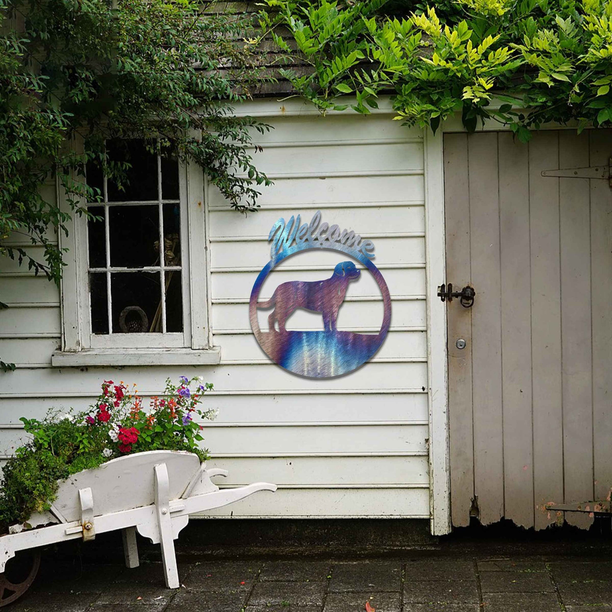 Metal garden art design showcasing a dog silhouette in profile, enclosed within a circular frame. Above the dog, the word Welcome is displayed, creating a warm and inviting atmosphere.