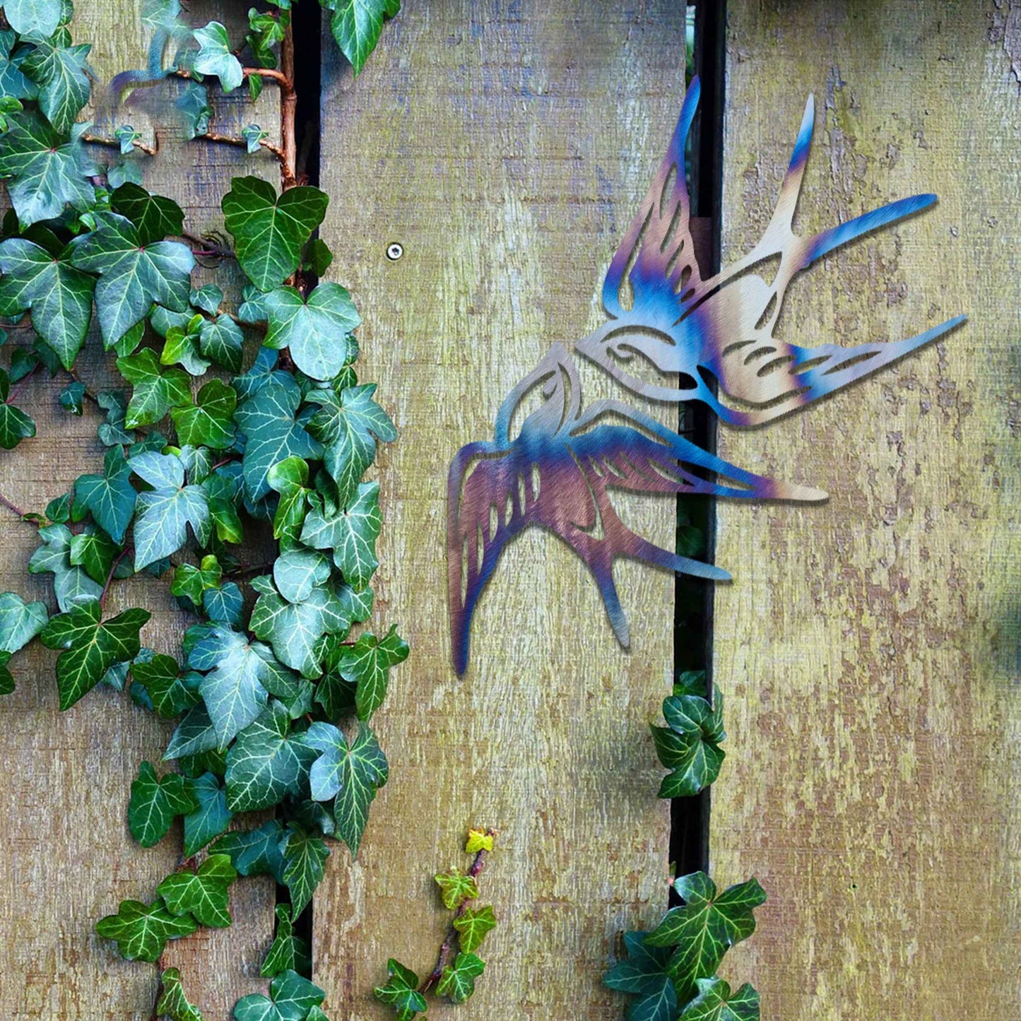 Metal garden decoration featuring a pair of swallows in flight, crafted with intricate detailing and a rustic finish, adding a graceful and timeless charm to outdoor walls or garden spaces.