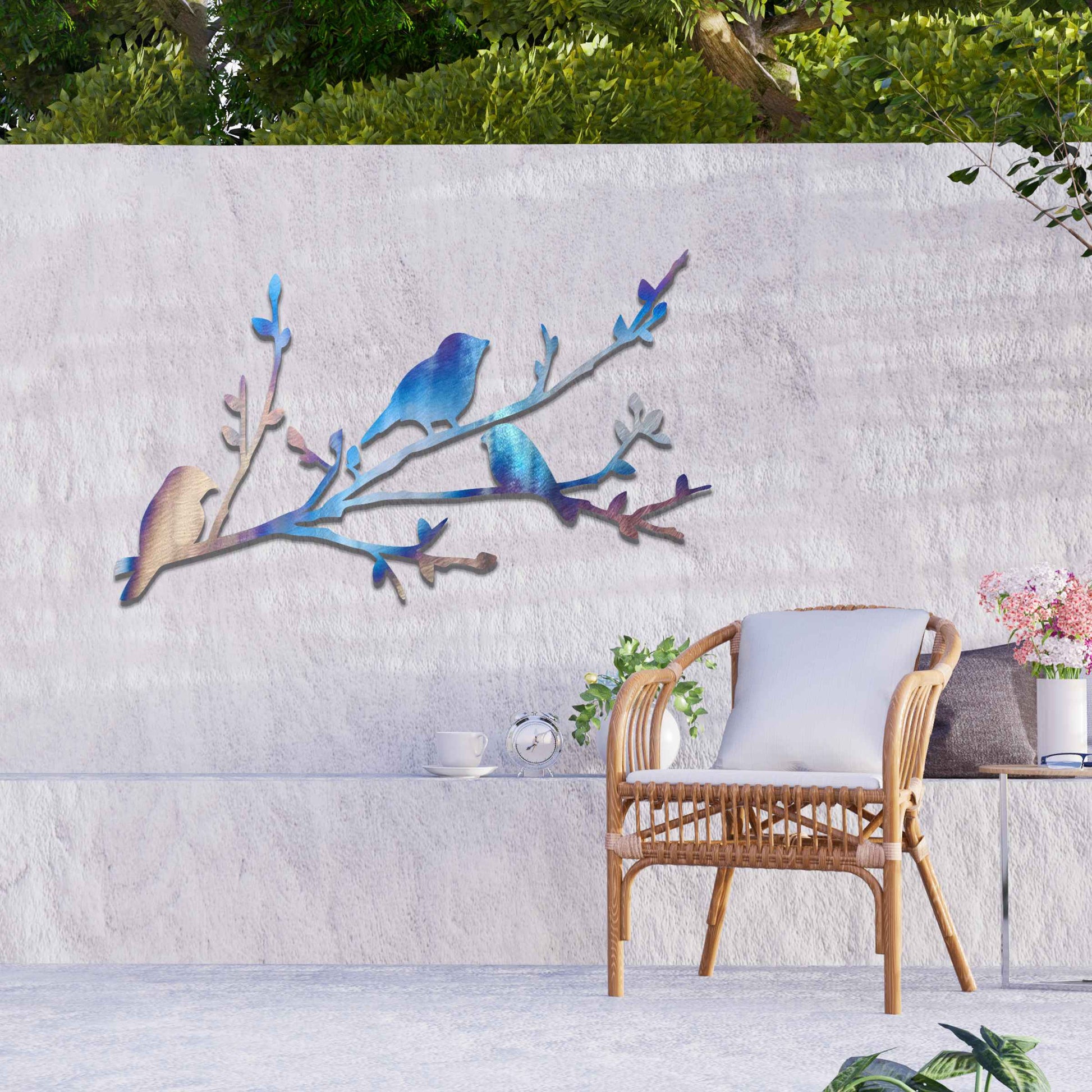 Metal garden decoration featuring three birds perched on a leafy branch, crafted with intricate cutout details and a rustic finish, adding a charming and natural touch to outdoor walls or garden spaces.
