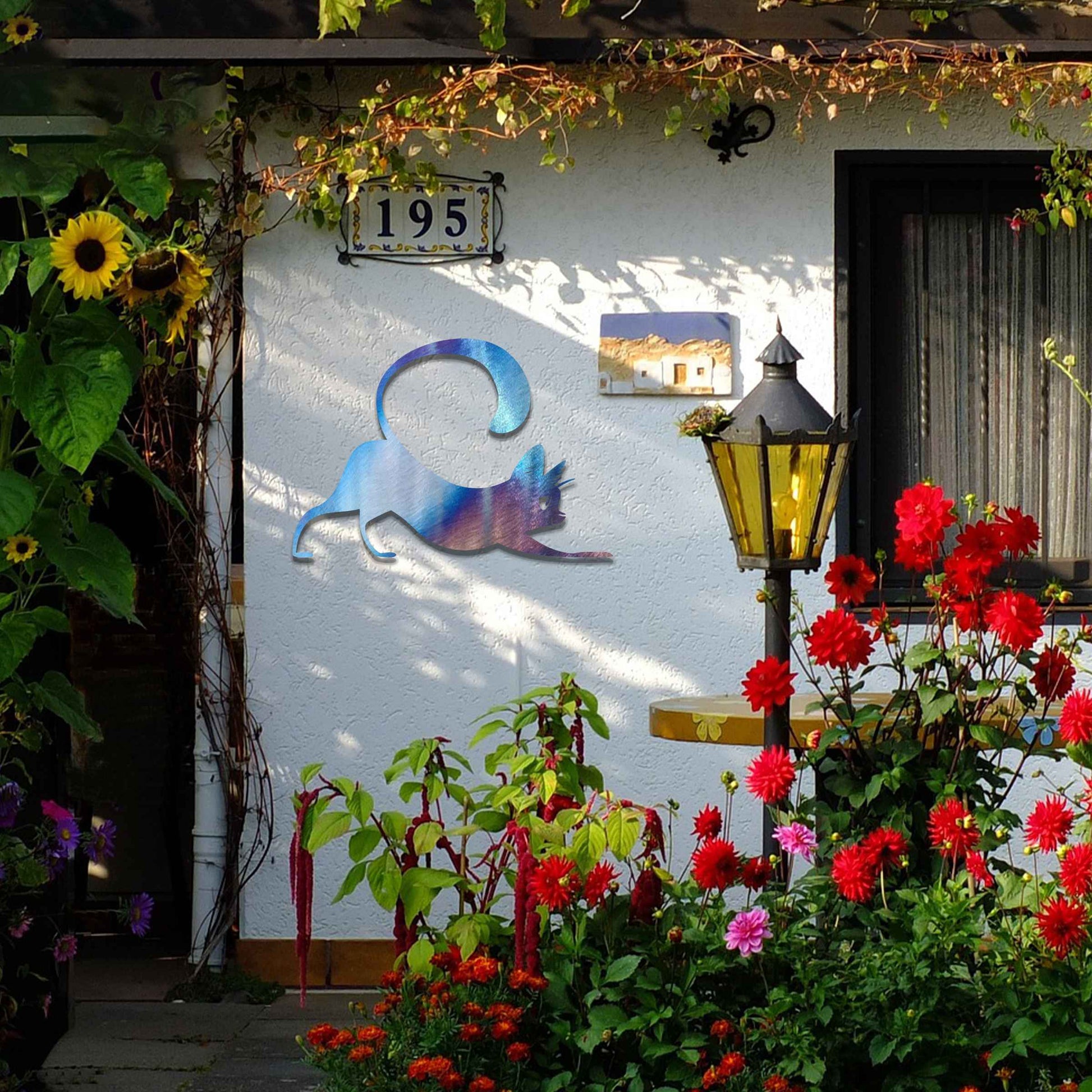 Metal garden decoration featuring a playful cat stretching with its tail curved upwards, crafted with sleek and elegant detailing, adding a touch of charm and liveliness to outdoor walls, fences, or doors.