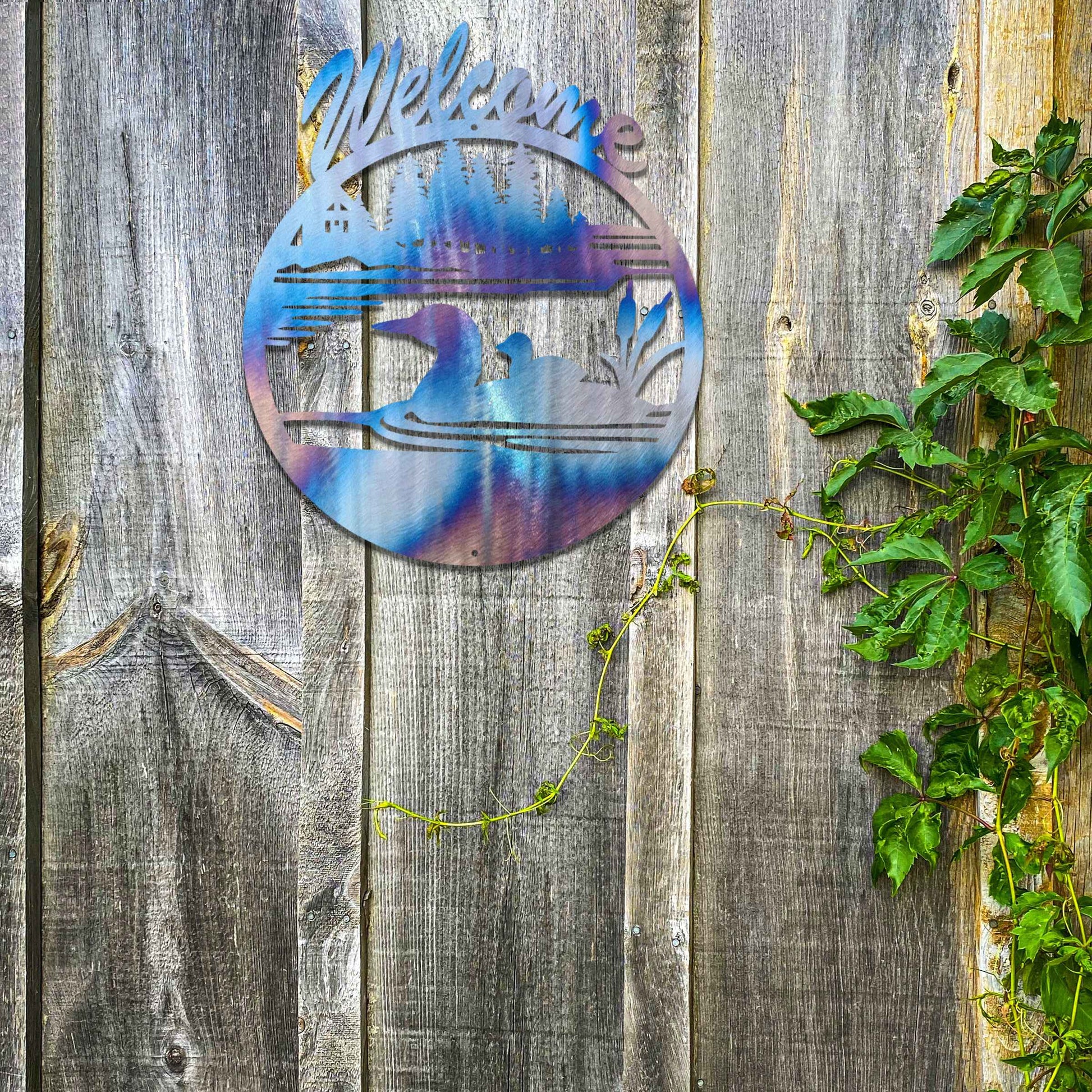This design features two ducks in a water setting with the word "Welcome" above. The rustic finish adds charm, and the circular shape encapsulates the peaceful imagery, making it ideal for gardens or entrances.