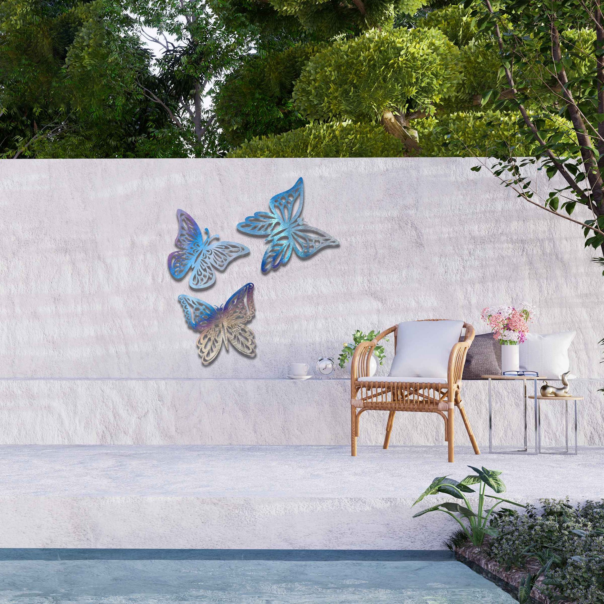 Set of metal garden decorations featuring three intricately designed butterflies with a rustic finish, adding a graceful and nature-inspired aesthetic to outdoor walls or garden spaces.