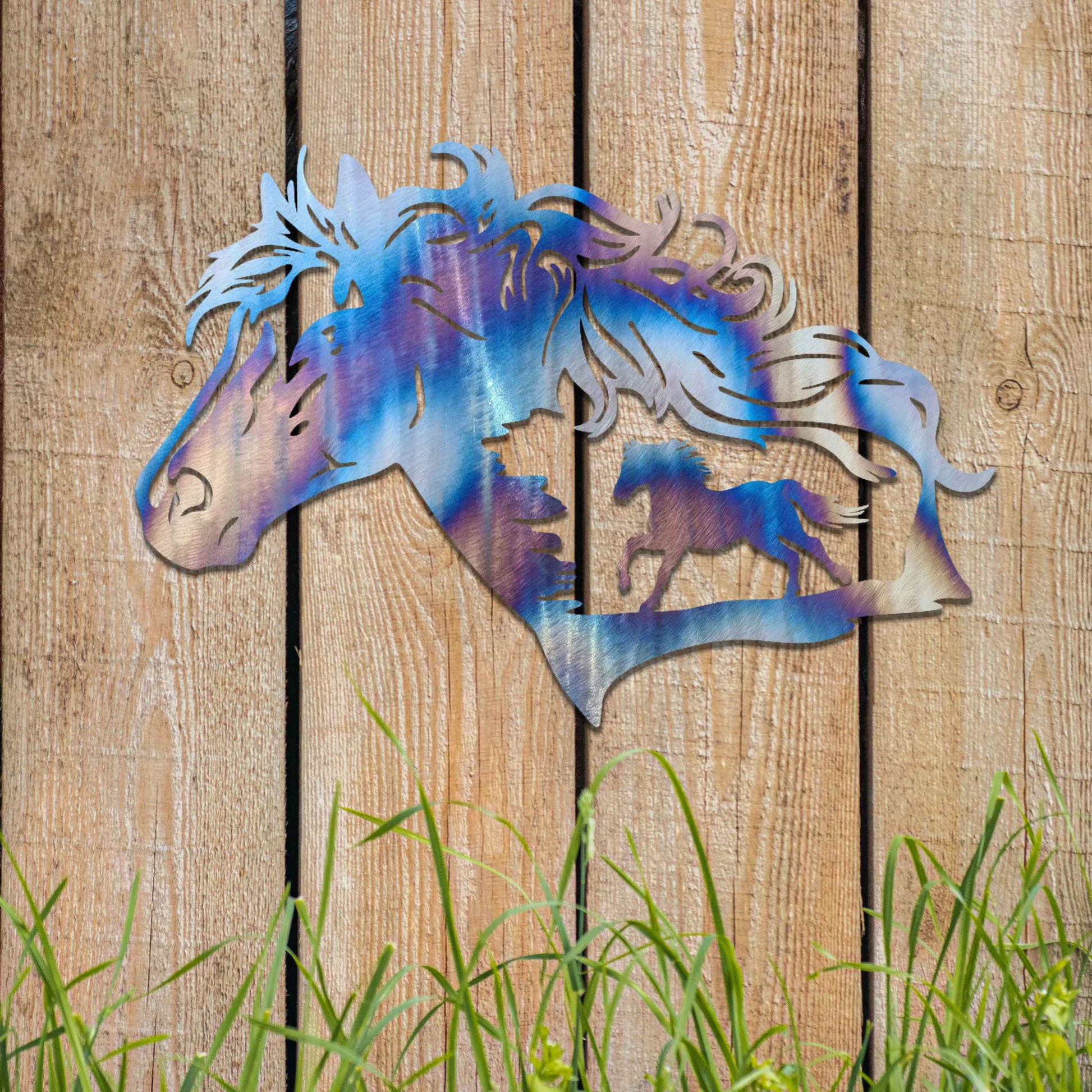 Metal wall decoration featuring a horse head silhouette with flowing mane details and a smaller horse figure within, crafted with intricate cutouts and a rustic finish, adding a majestic and artistic touch to indoor or outdoor spaces.