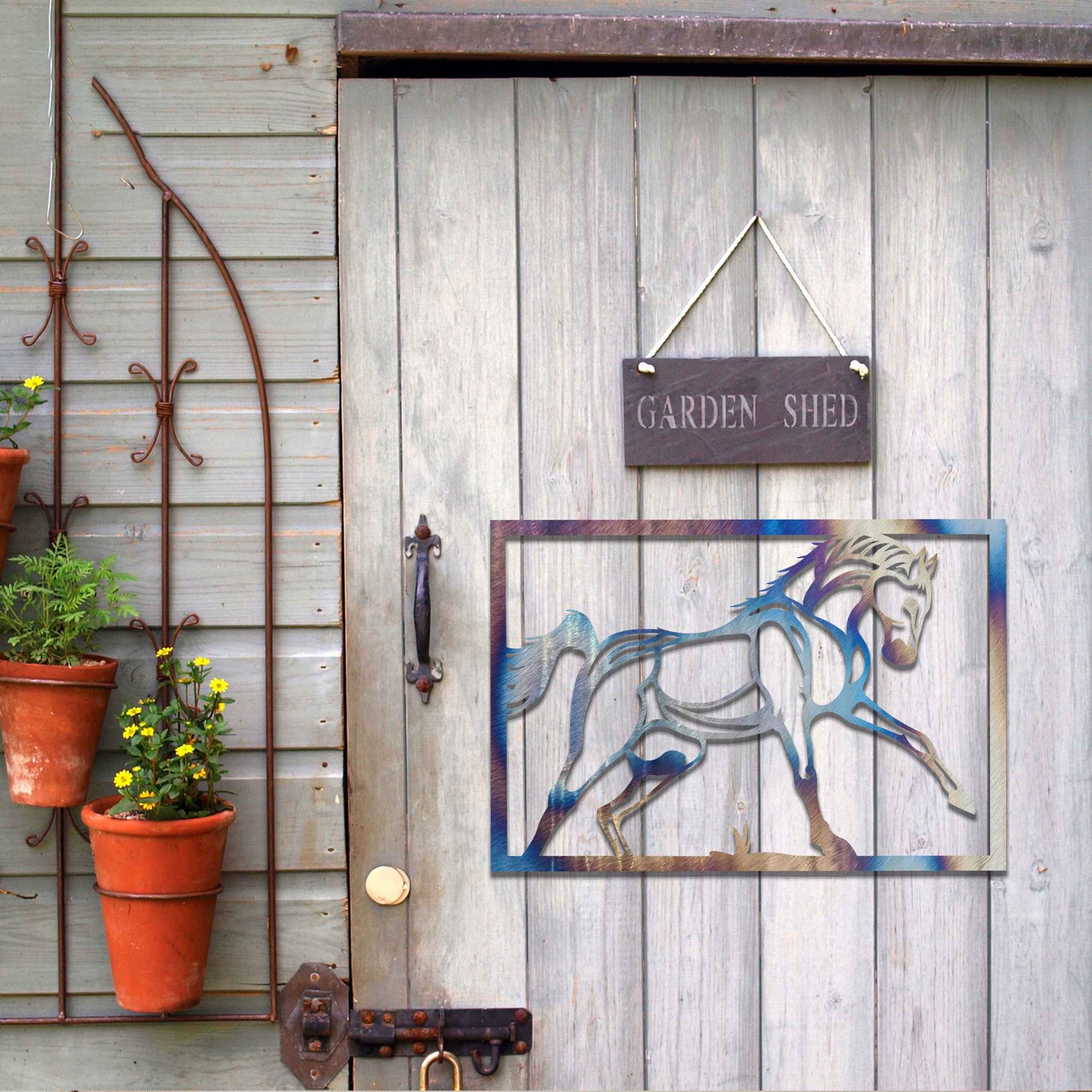 Metal wall art featuring an elegant horse in motion, outlined with bold lines and set within a rectangular frame. The artwork captures the graceful movement of the horse in a minimalistic style.