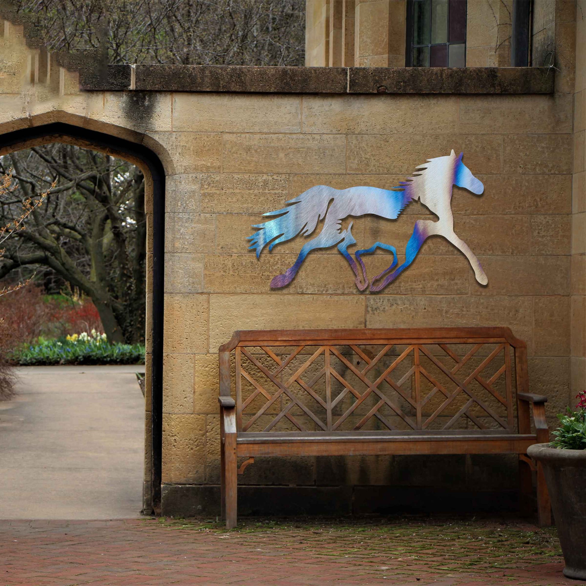 Metal wall art of a running horse, captured in motion with flowing mane and tail. The horse is designed with fluid lines, giving a dynamic impression of speed and energy.