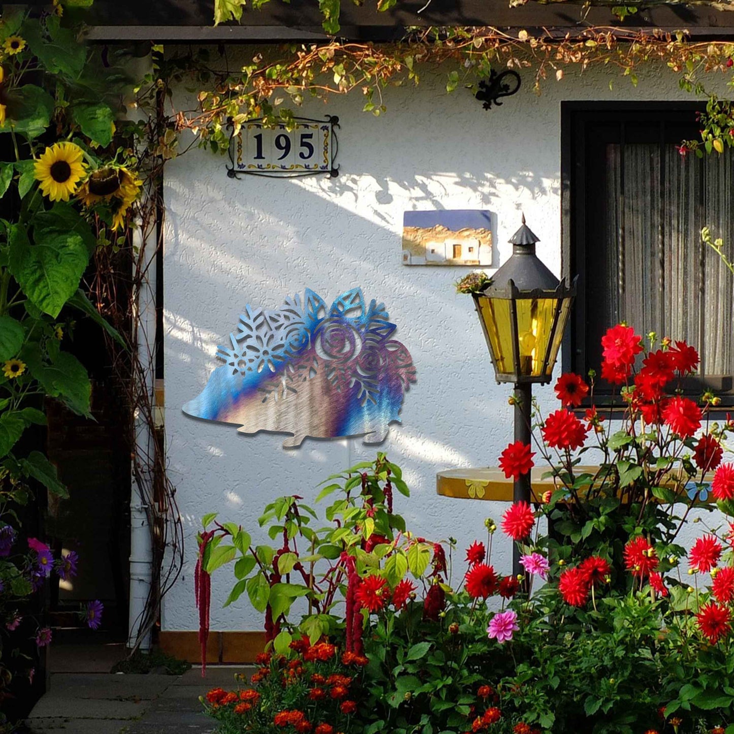 Metal garden decoration featuring a hedgehog-shaped design with intricate floral cutouts, adding a charming and rustic touch to outdoor spaces, perfectly blending with garden greenery.