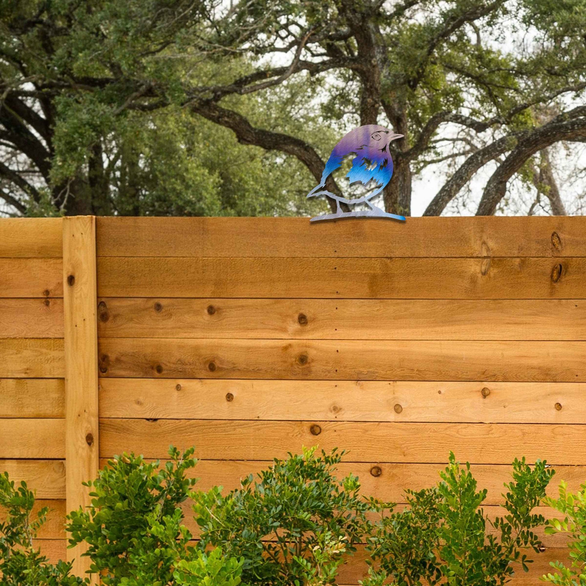 Metal garden decoration featuring a robin silhouette with a rustic finish, designed to sit atop fences or posts, adding a charming and natural touch to outdoor garden spaces.